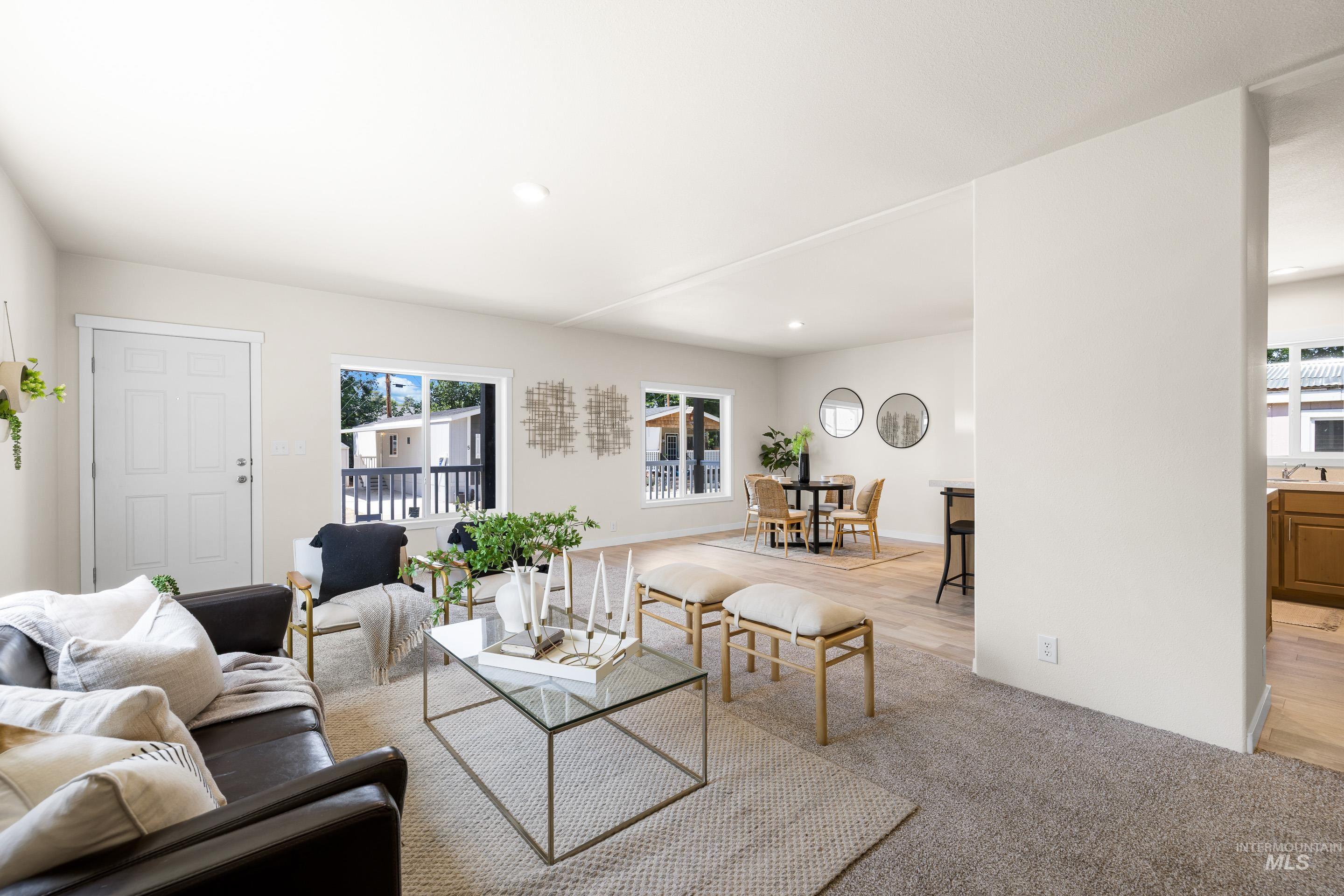 Living area with recessed lighting and light carpet