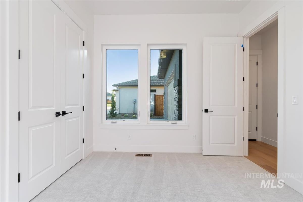 Unfurnished bedroom featuring carpet flooring and baseboards
