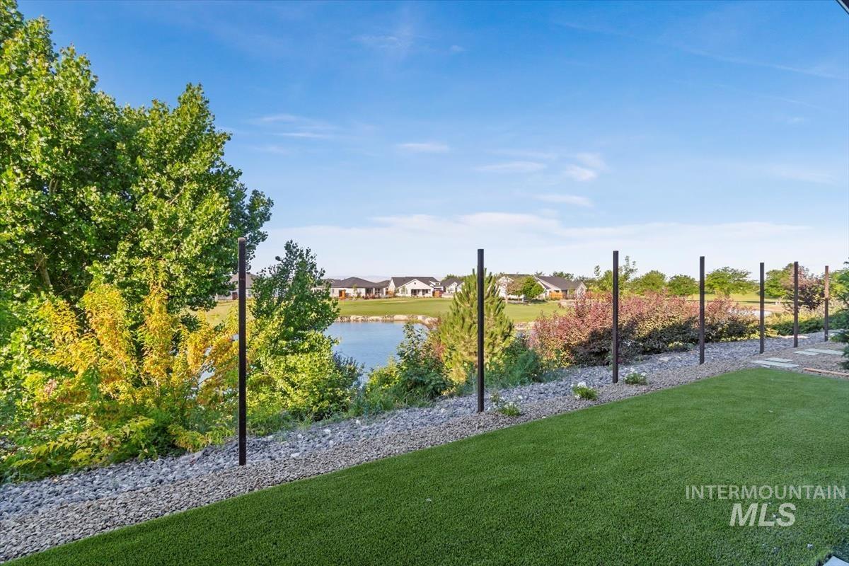 View of home's community featuring a yard and a water view