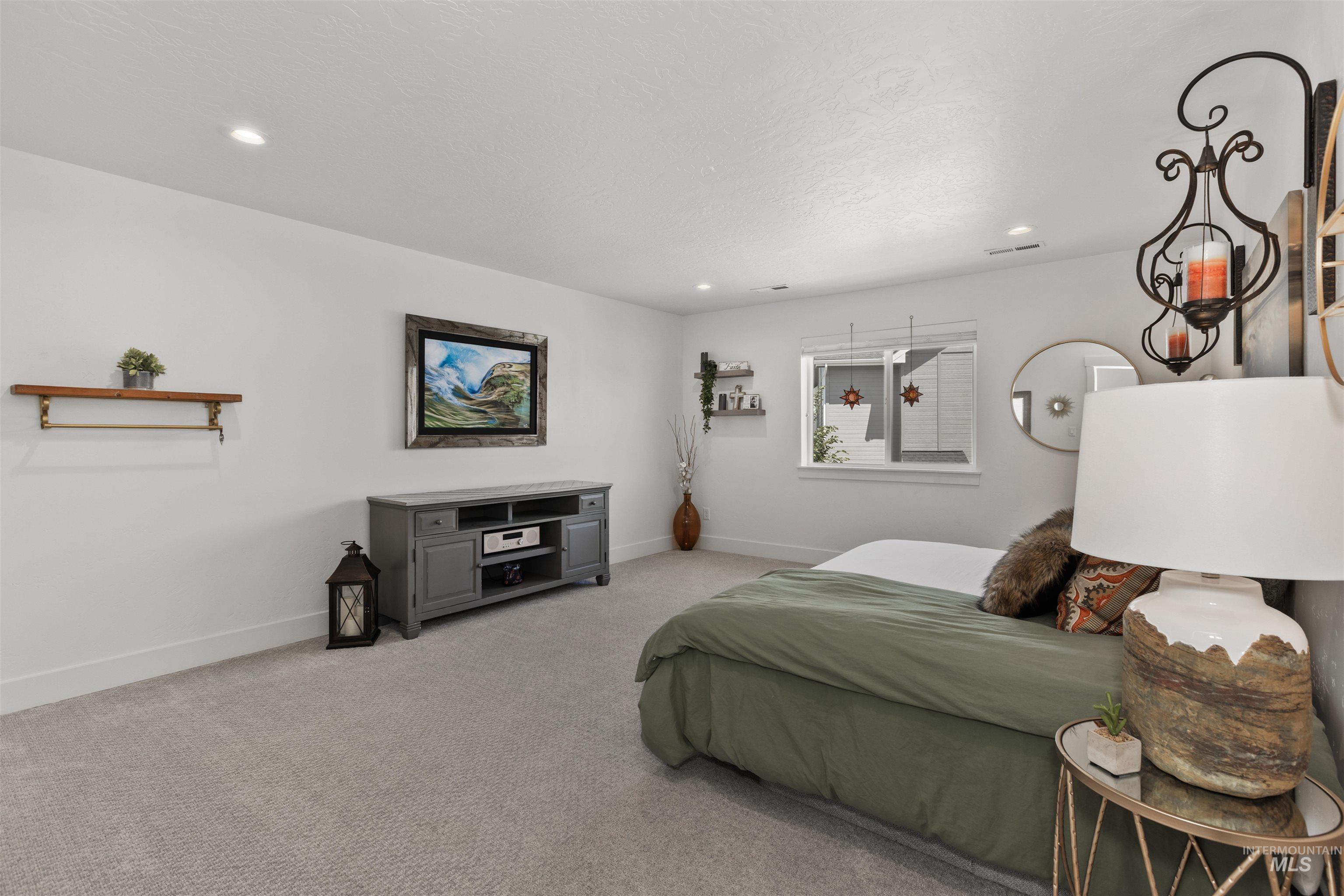 Bedroom featuring light carpet and recessed lighting