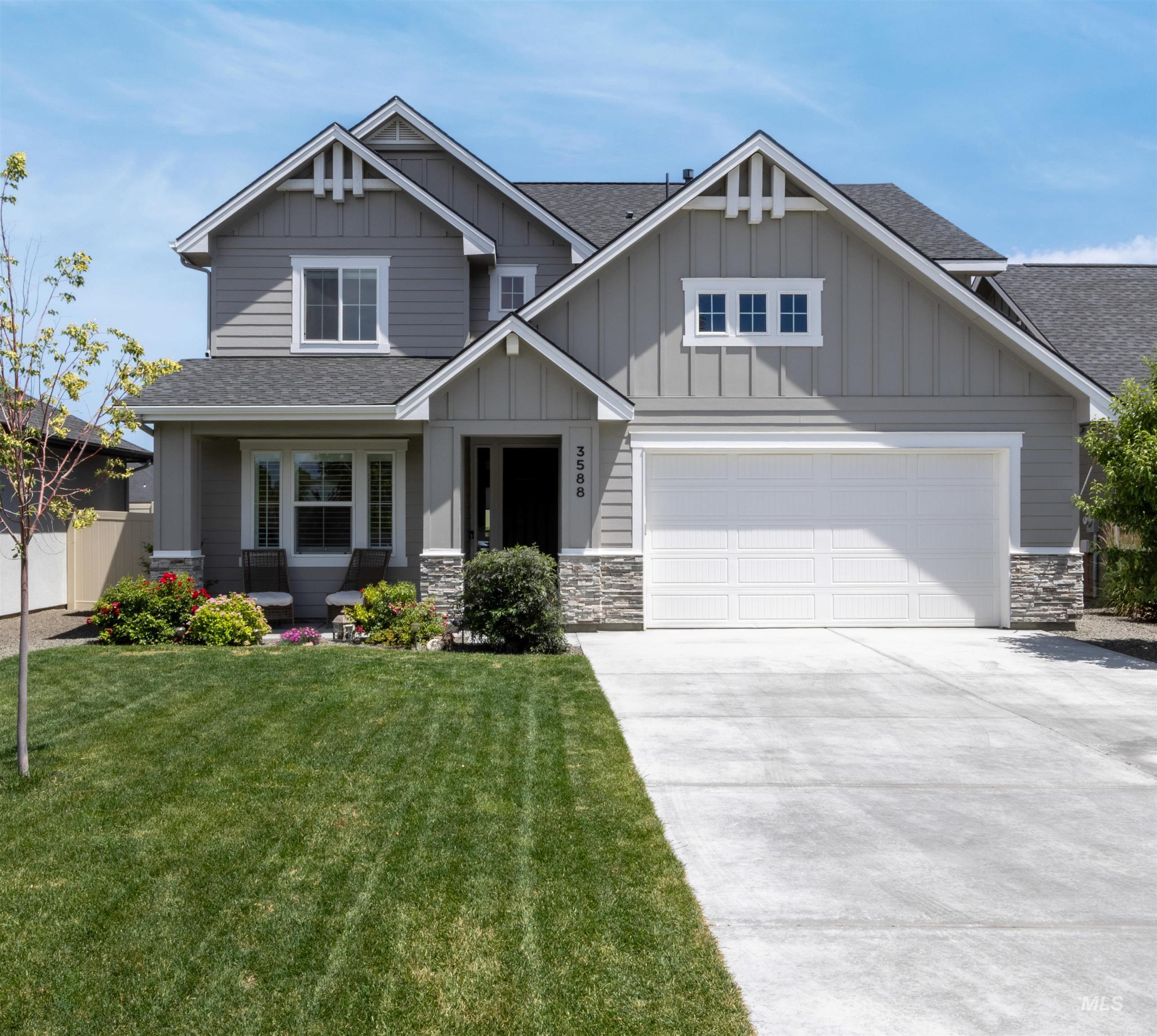 Craftsman house with roof with shingles, board and batten siding, stone siding, and a front yard