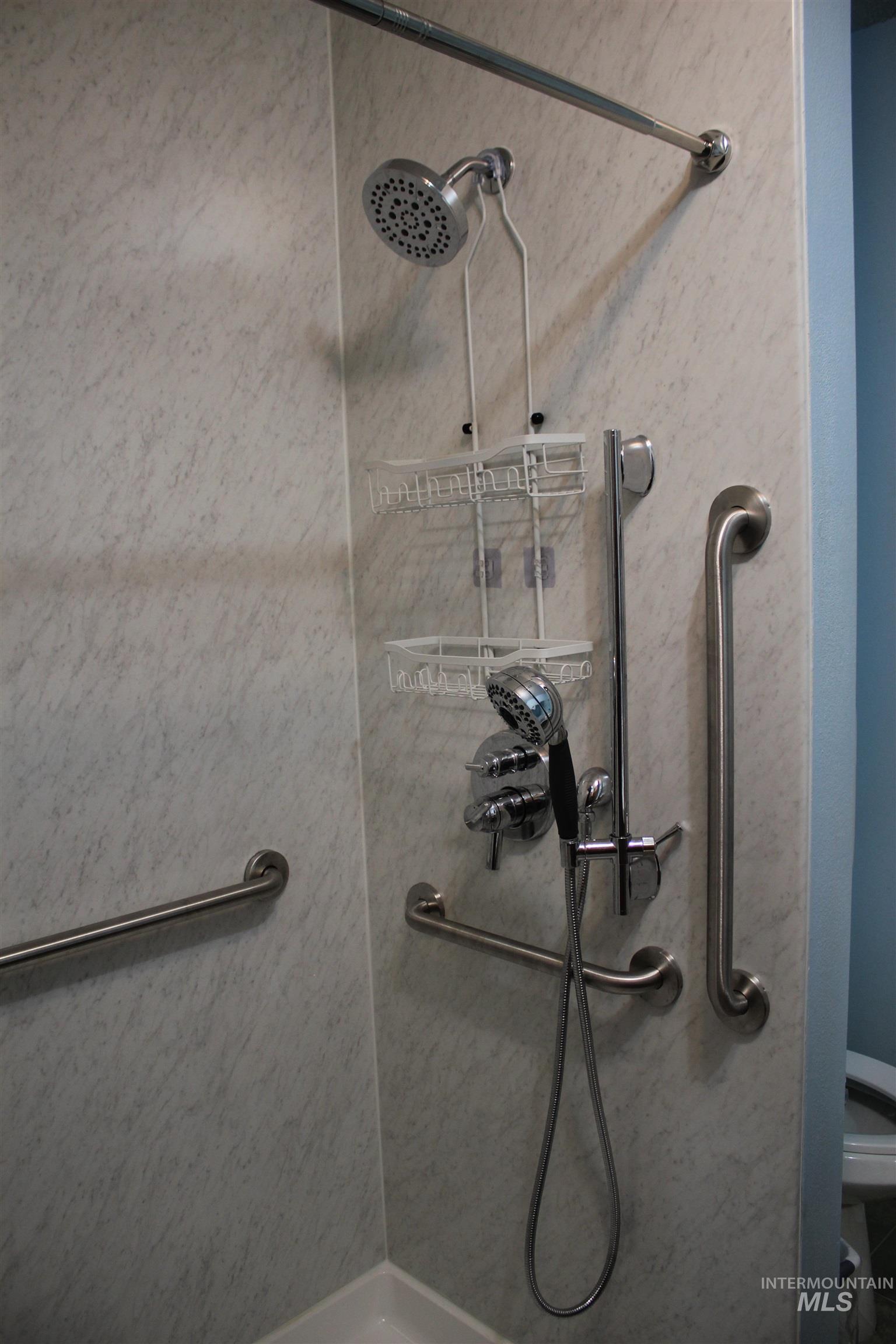 Full bath featuring a shower and toilet