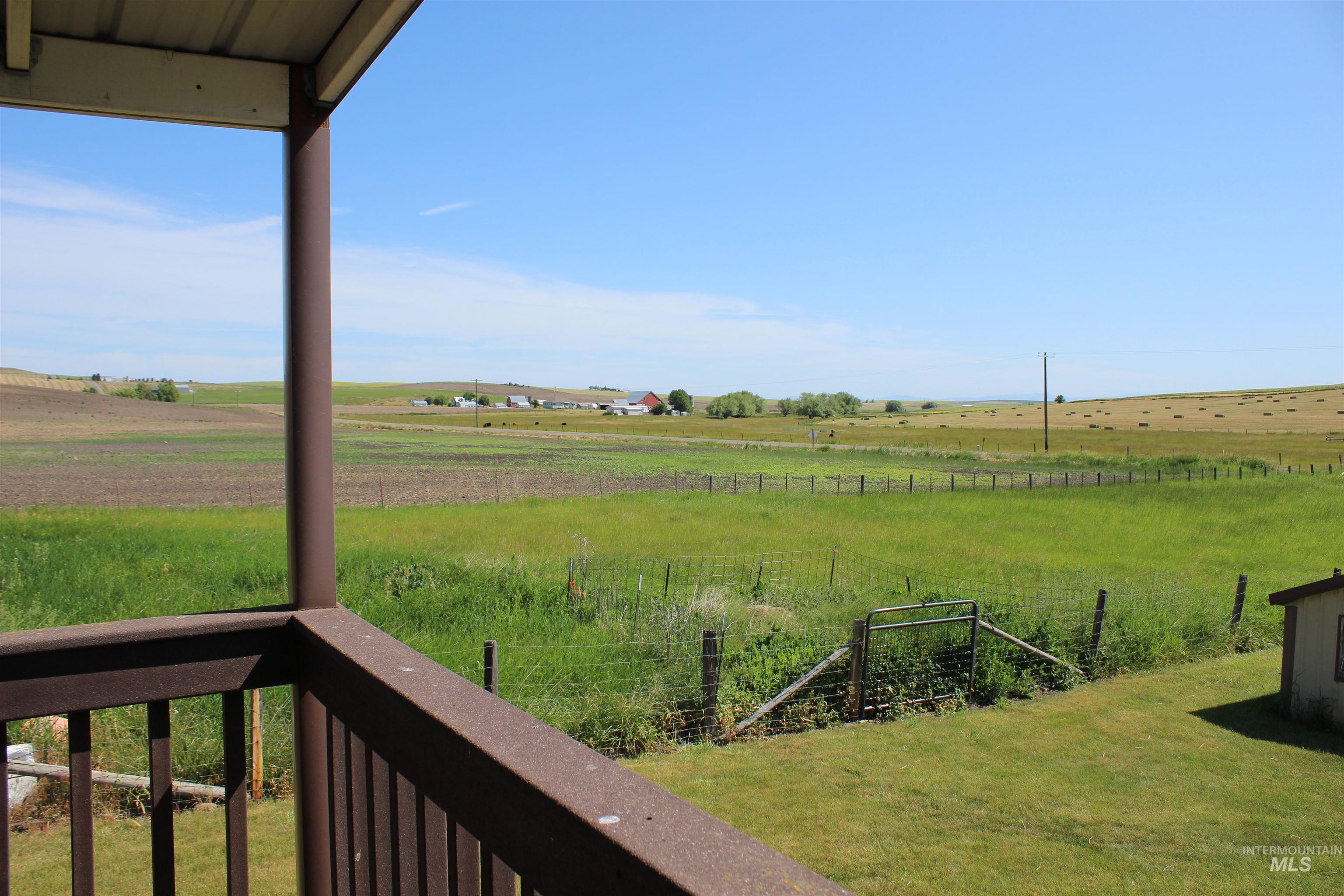 View of yard with a view of rural / pastoral area and a balcony