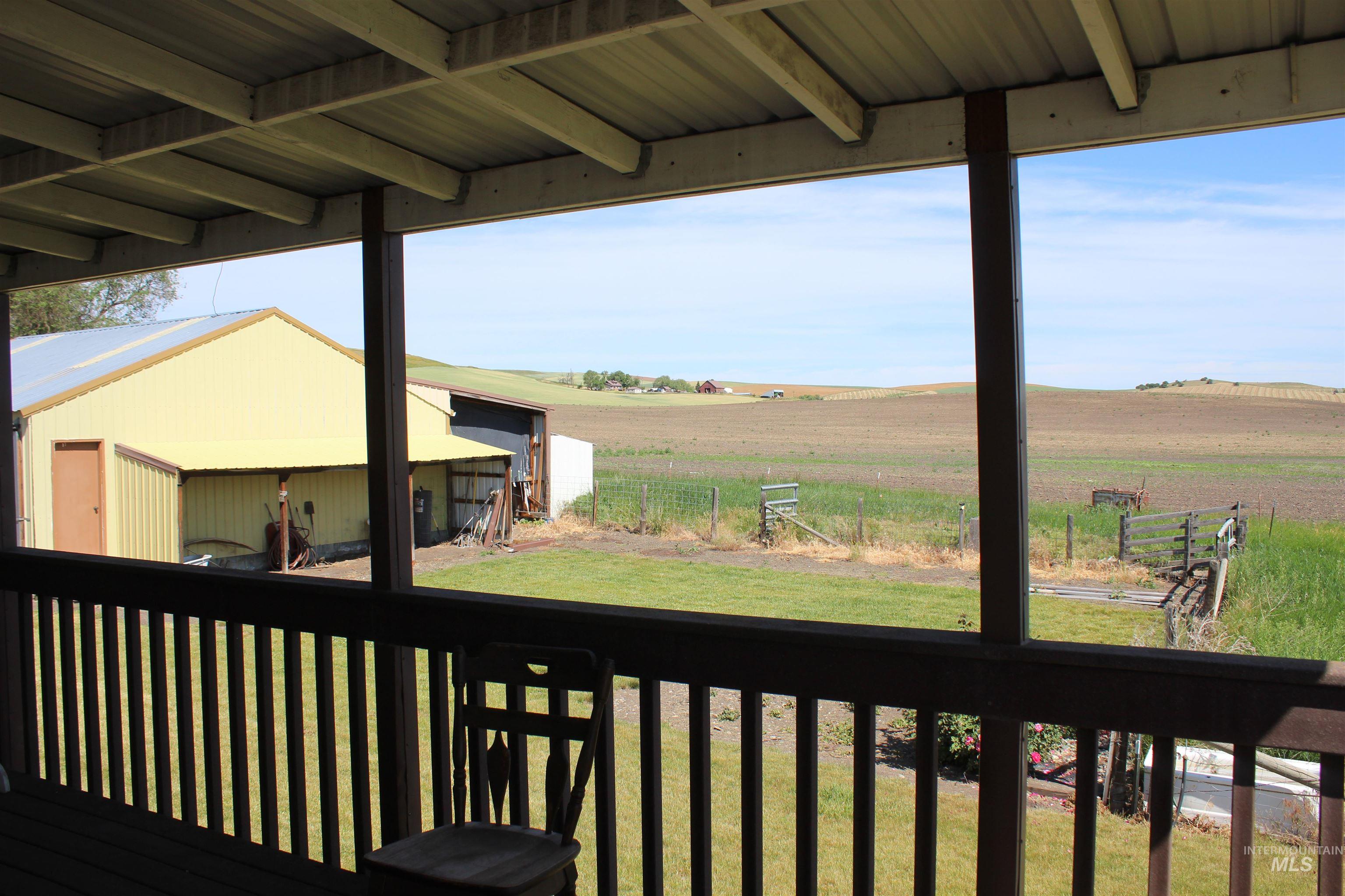 Wooden terrace with a rural view and an outbuilding
