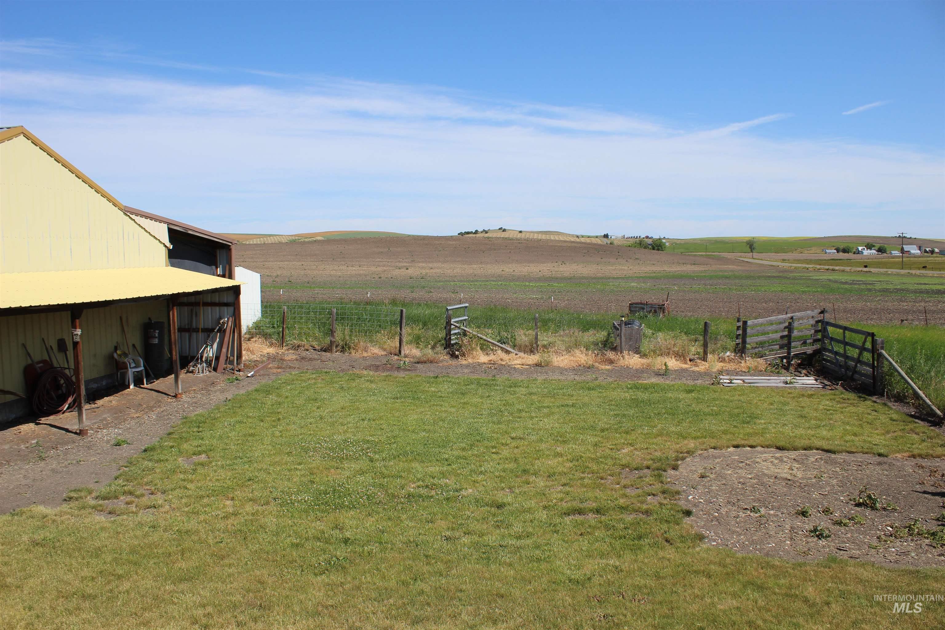 View of yard with a rural view and an outdoor structure