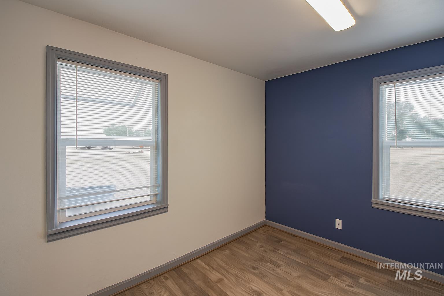 Empty room with wood finished floors and baseboards