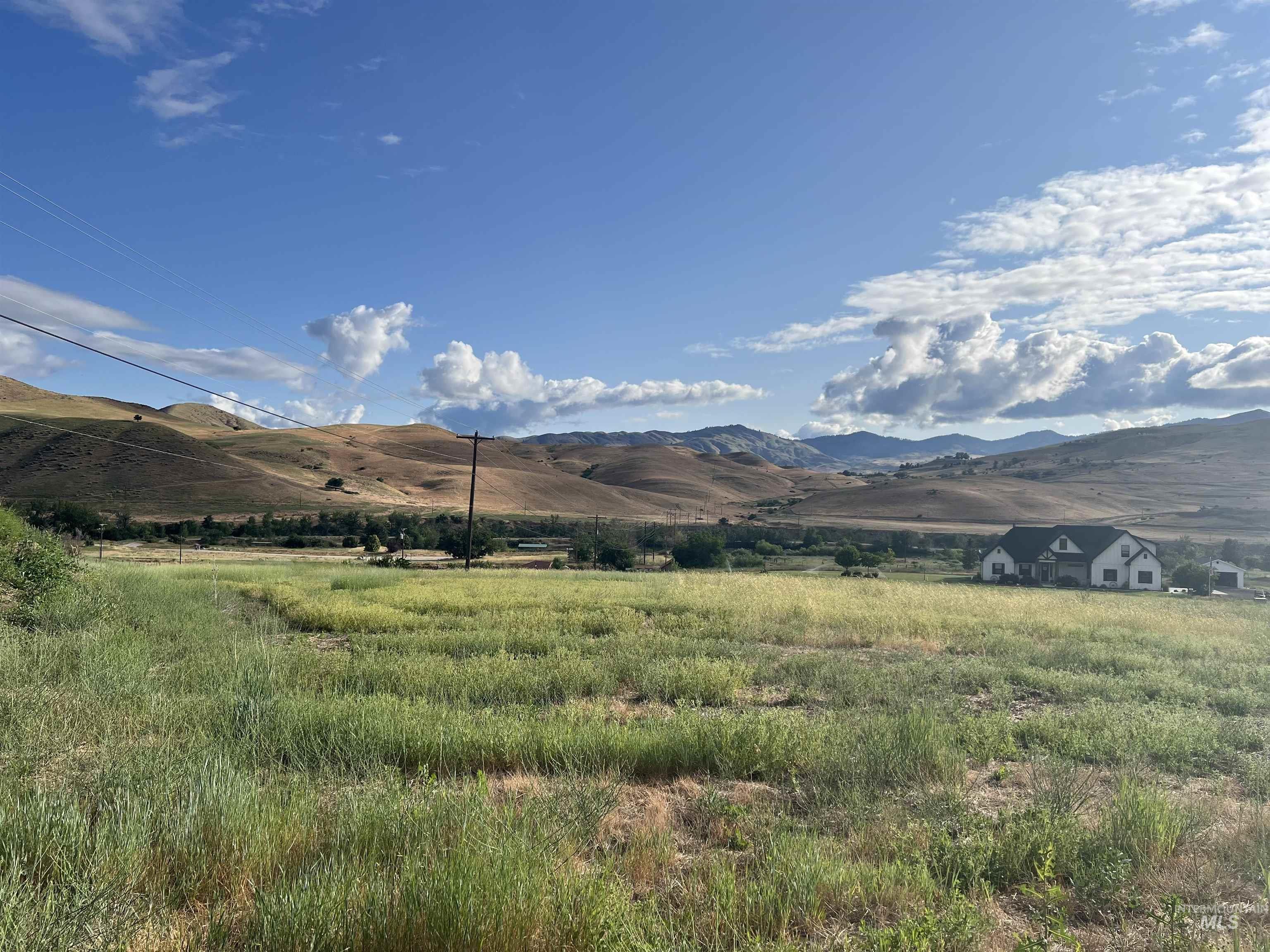 View of mountain backdrop with rural landscape