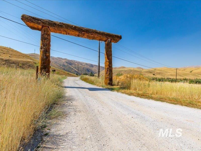 View of dirt / gravel road with a mountain view