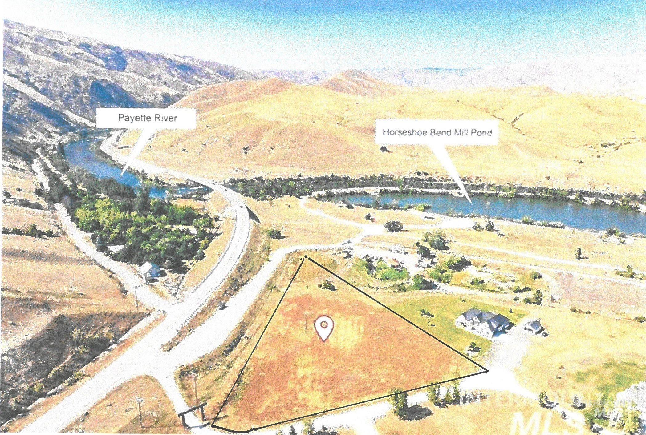Aerial view of property and surrounding area with property boundaries highlighted and a water and mountain view