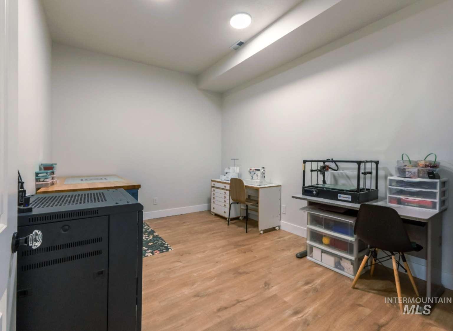 Office area featuring baseboards and light wood finished floors