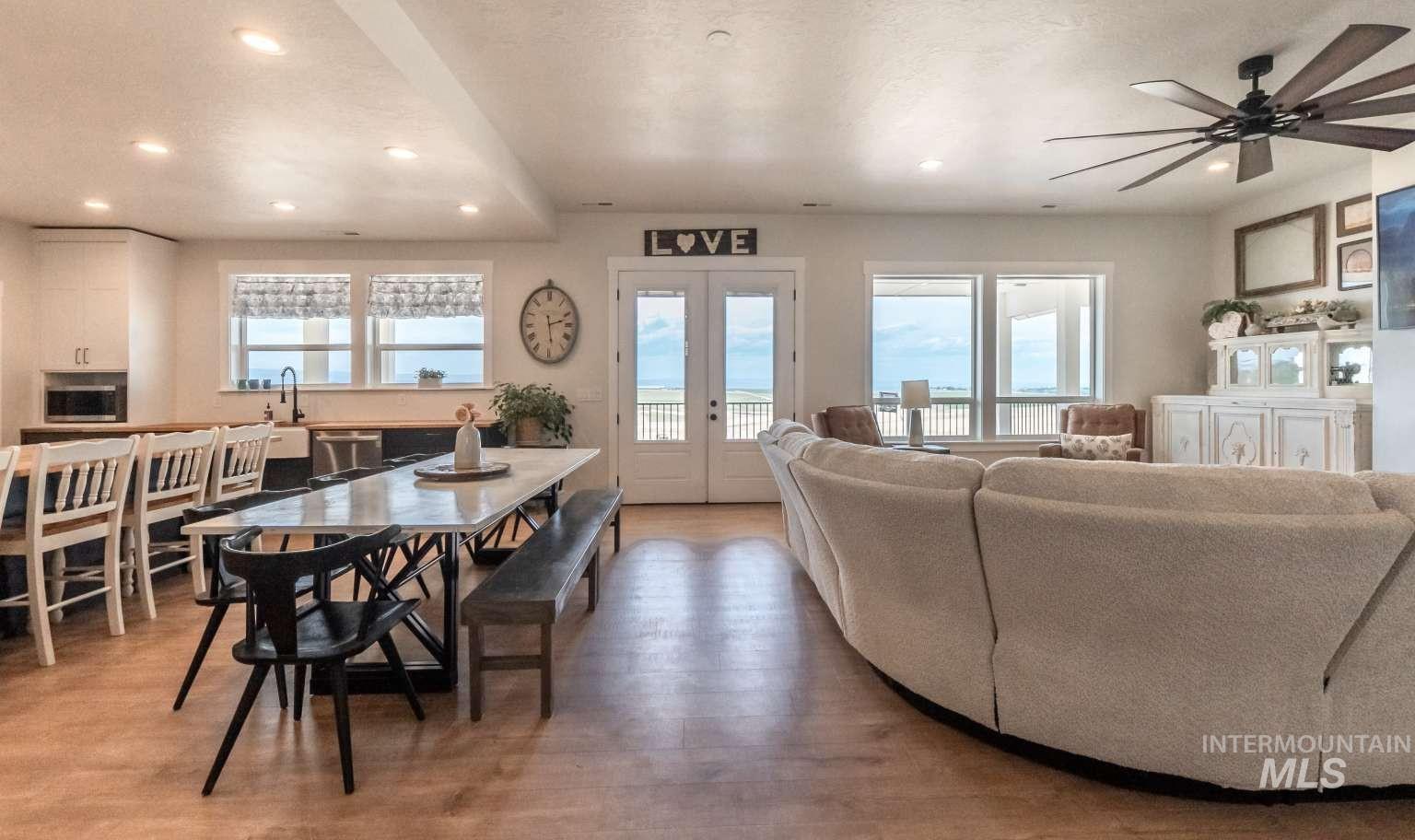 Living room featuring light wood finished floors, recessed lighting, ceiling fan, french doors, and a textured ceiling