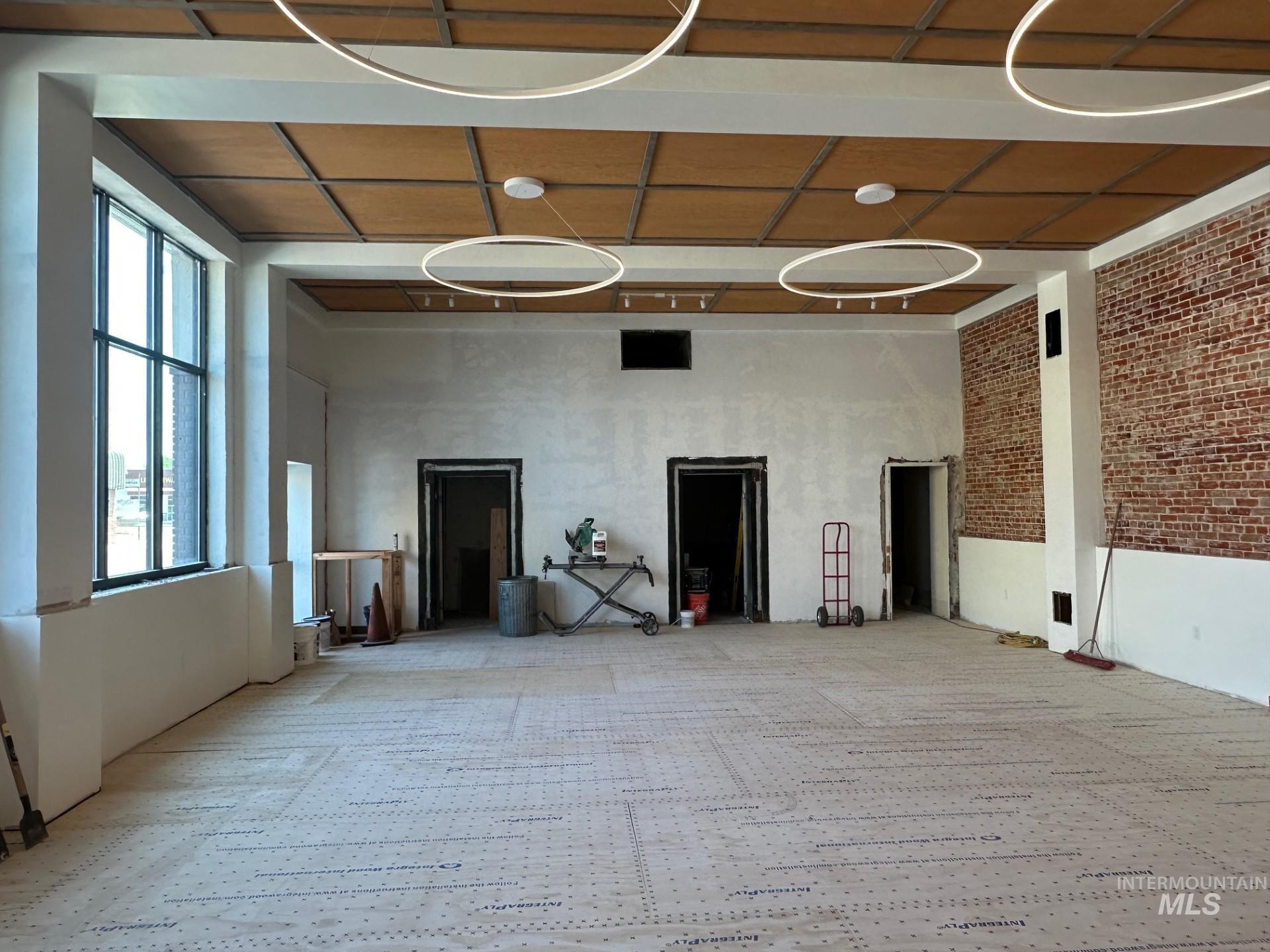 Spare room with brick wall and a smoke detector