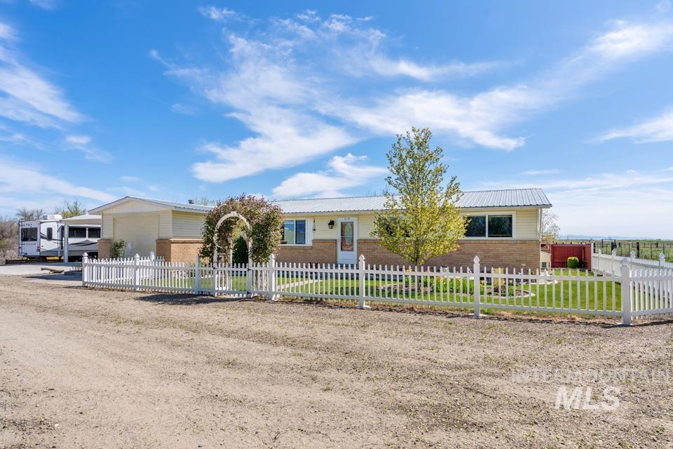 Ranch-style home with brick siding and a fenced front yard