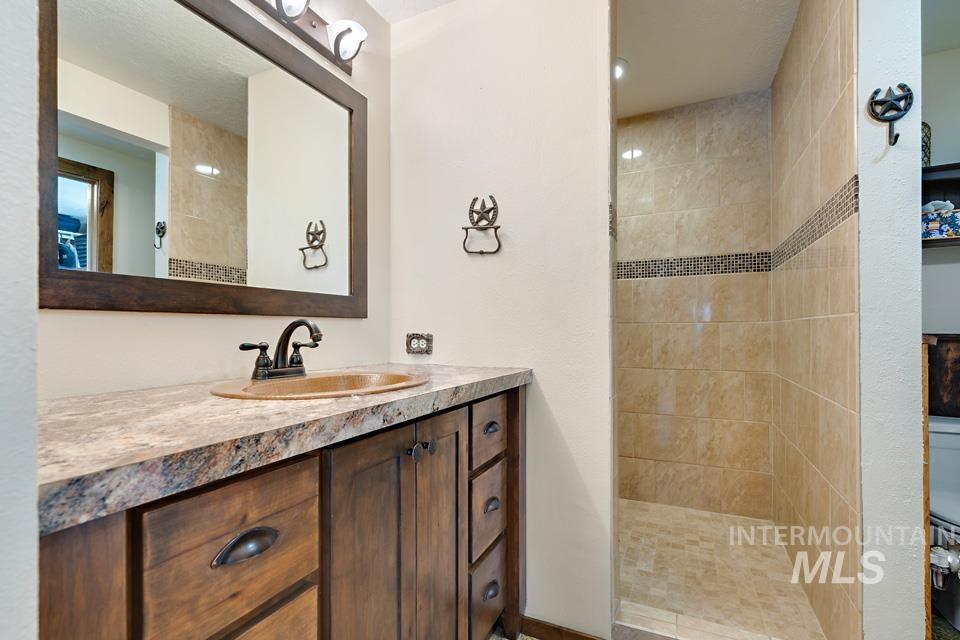 Full bath with a walk in shower and vanity