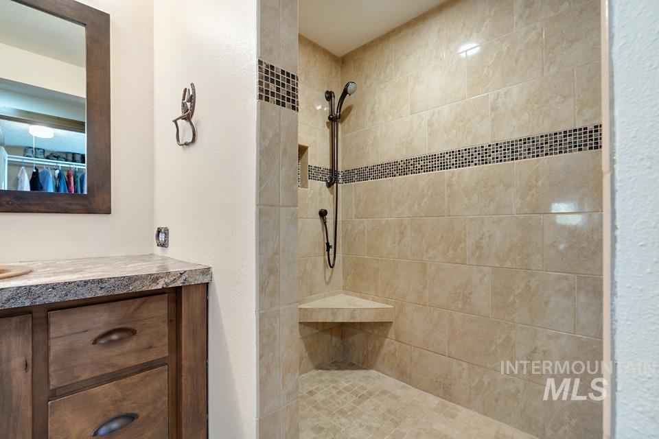 Bathroom with a tile shower and vanity