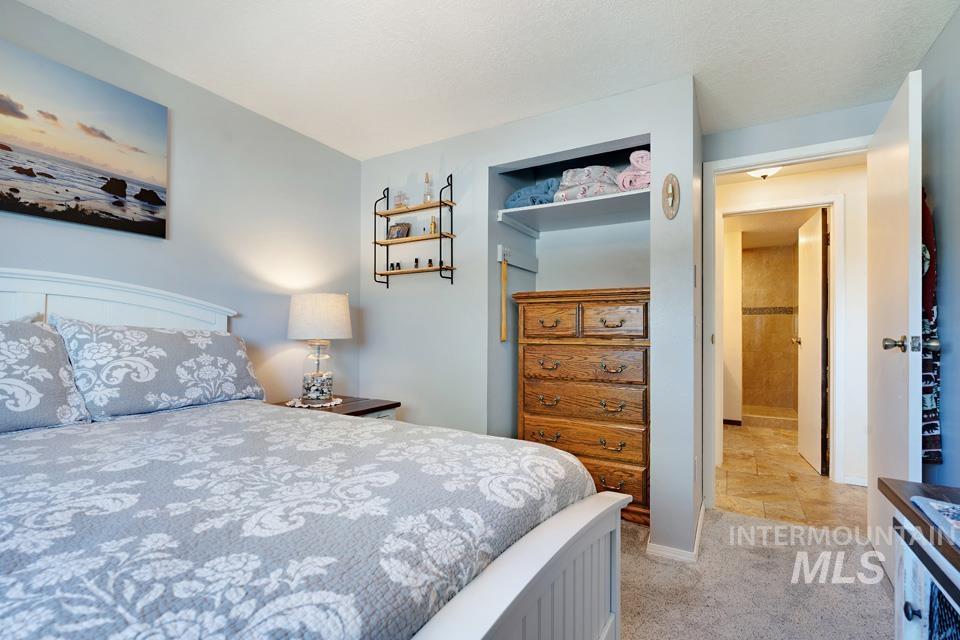 Bedroom featuring light colored carpet and baseboards