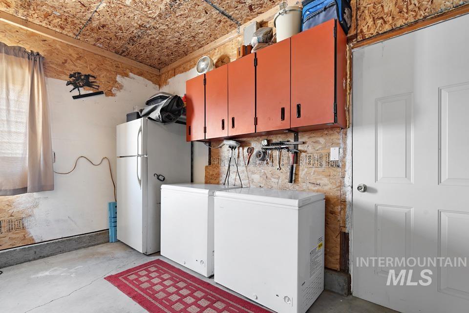 Washroom with washing machine and dryer and cabinet space