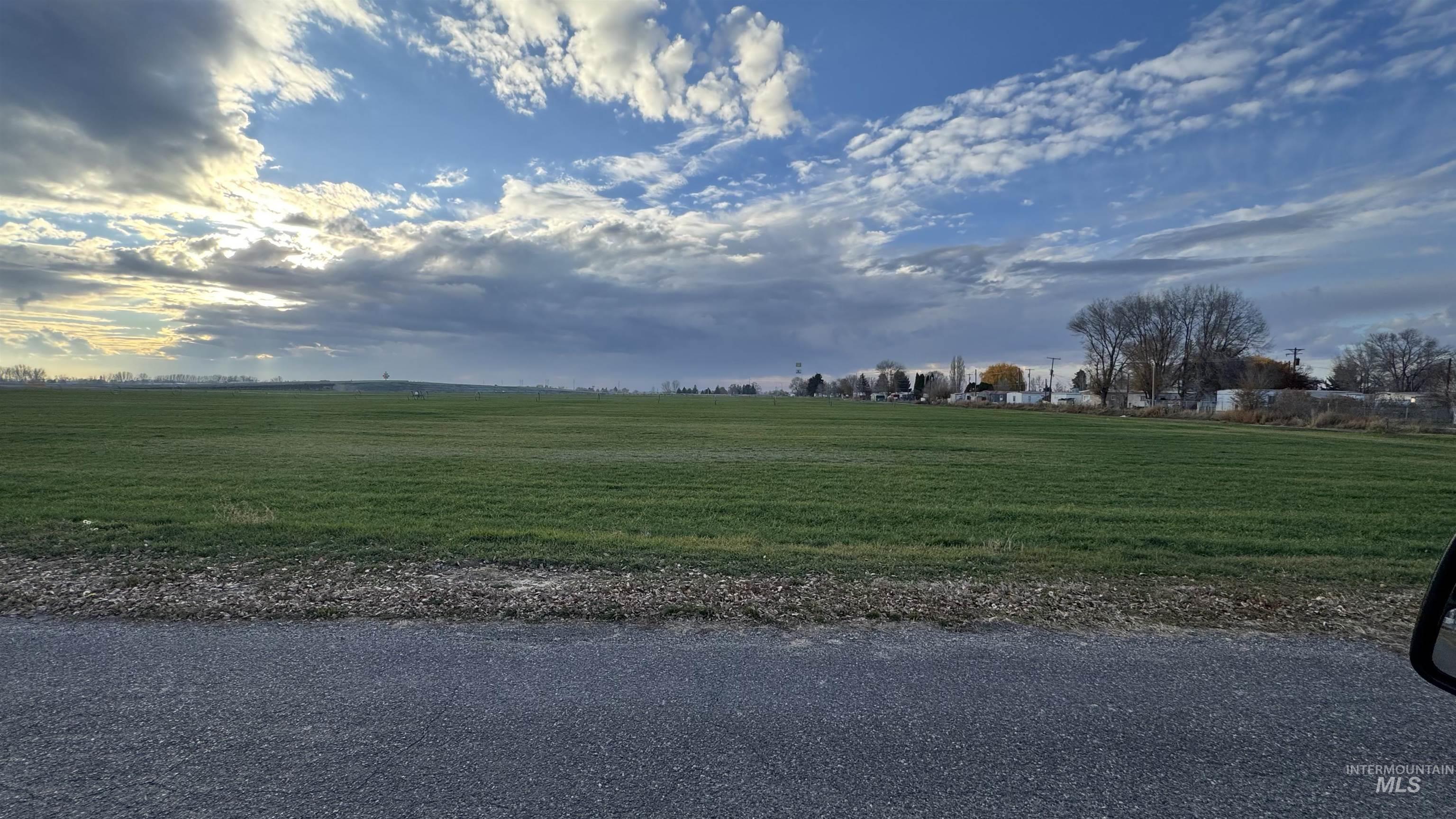 View of asphalt street with a rural view