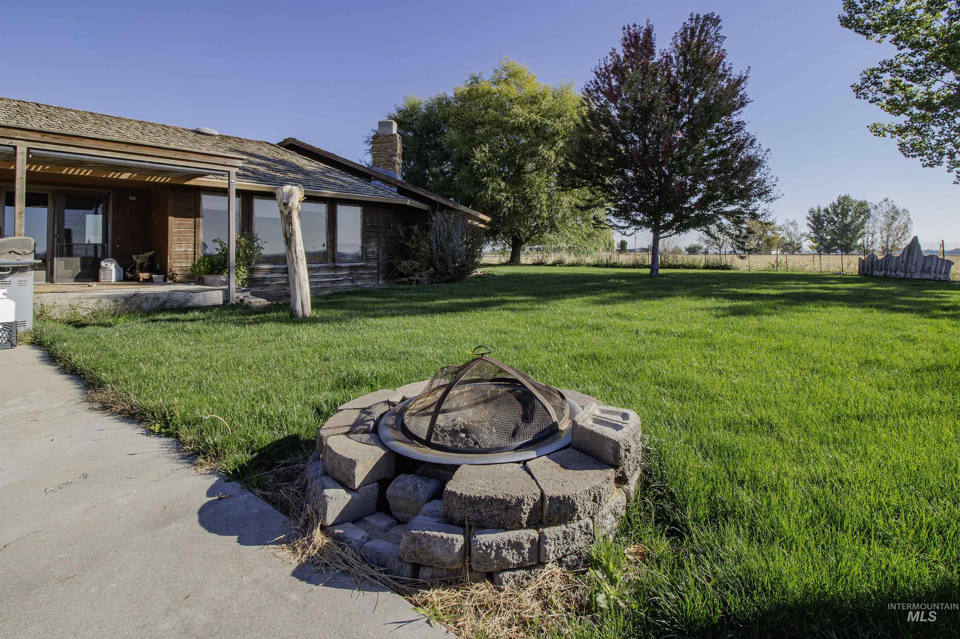 View of yard featuring a fire pit and a patio