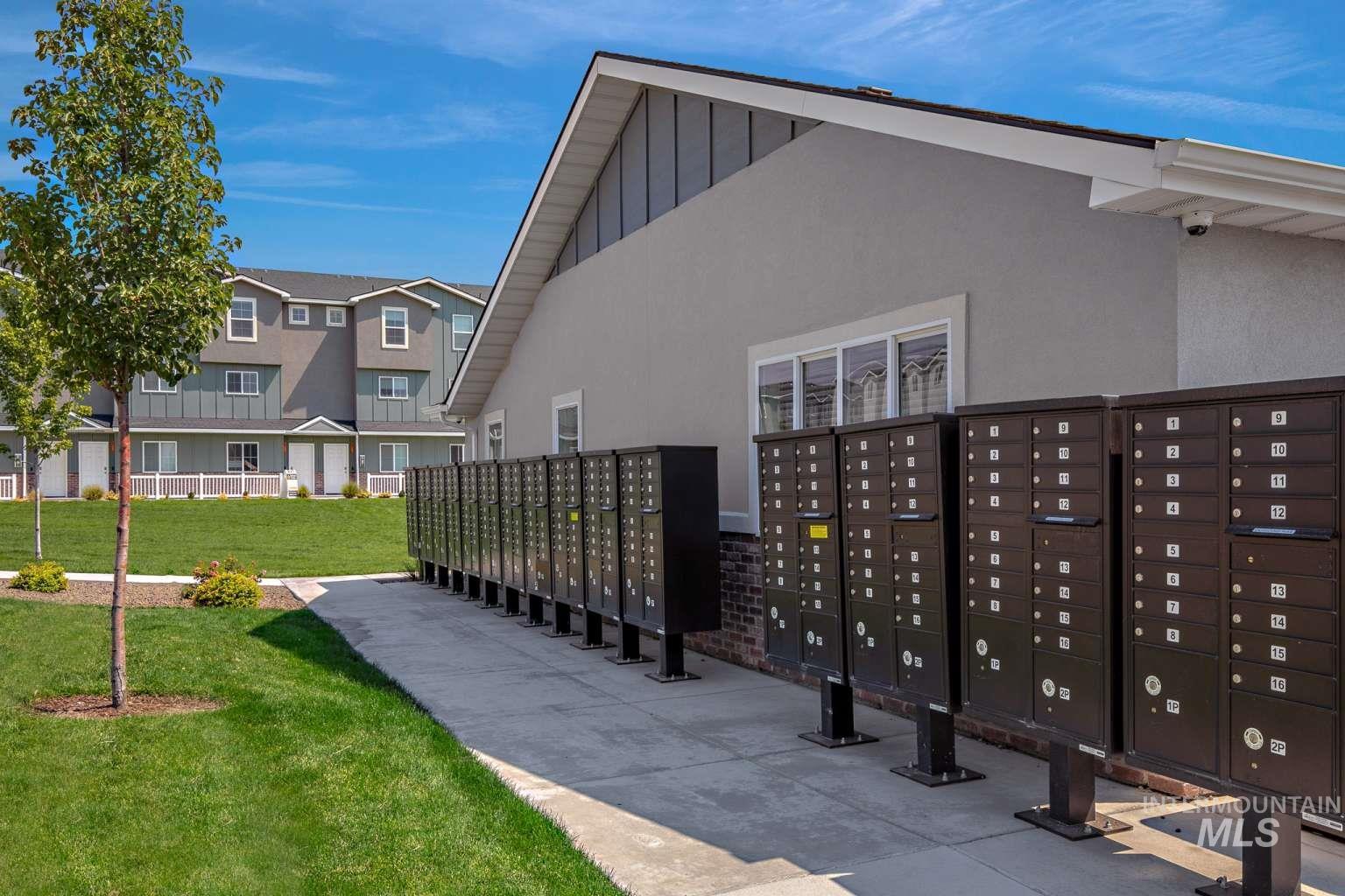 Surrounding community with mail area and a lawn