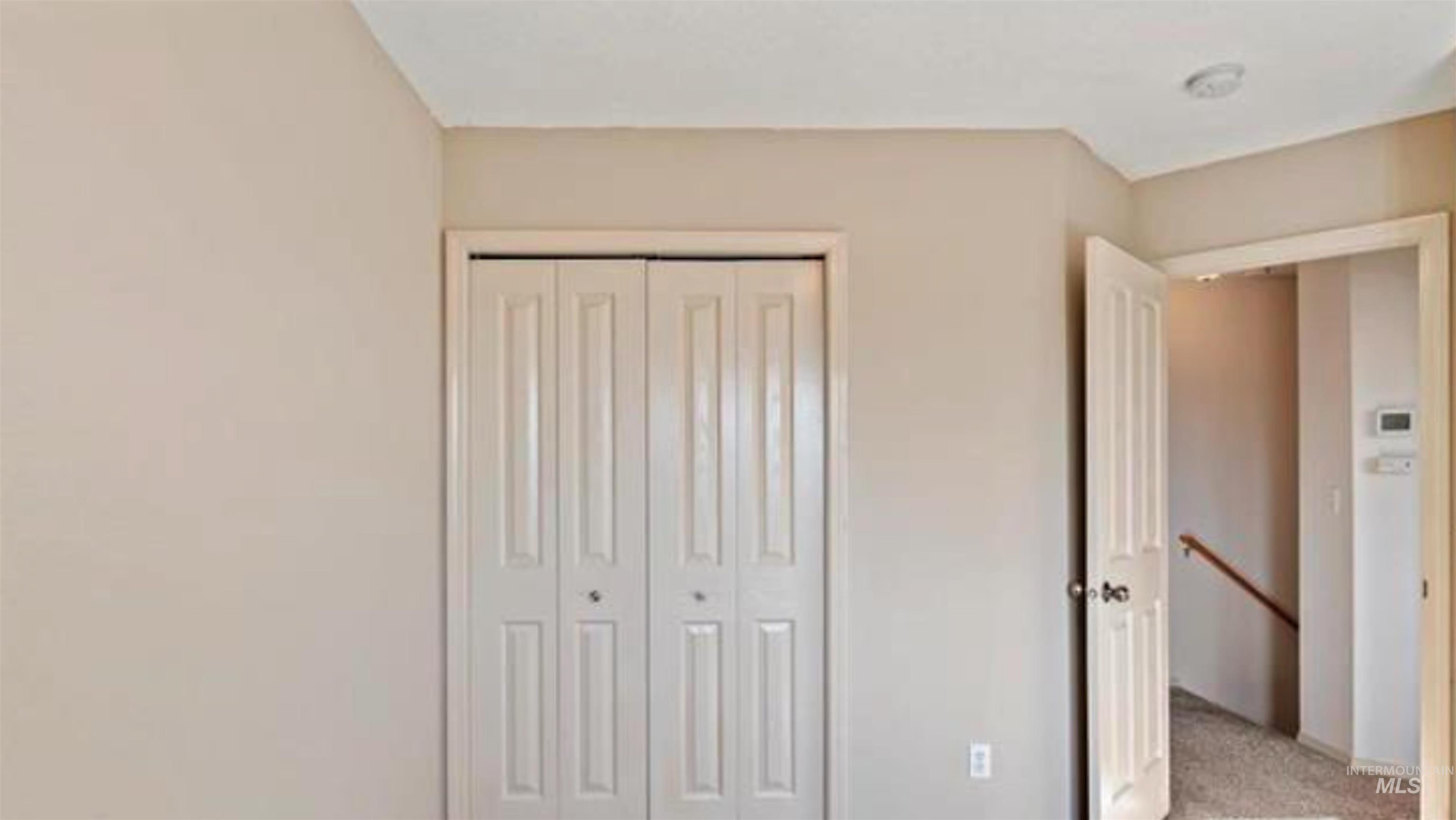 Unfurnished bedroom with a closet and light colored carpet
