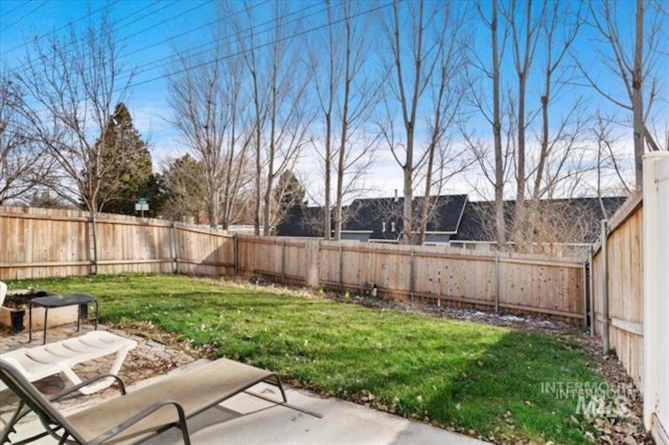 Fenced backyard with a patio