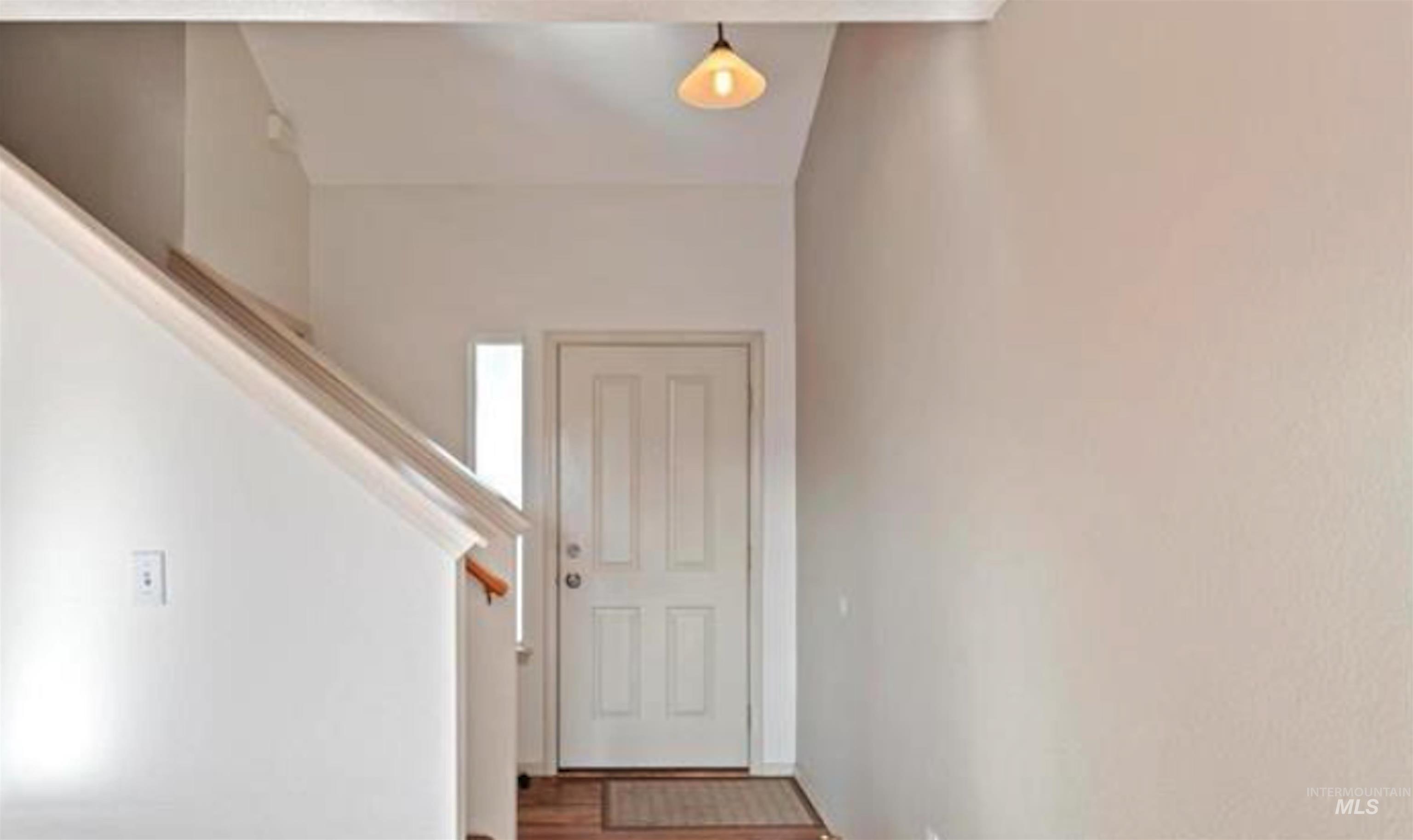 Entryway featuring wood finished floors and stairway