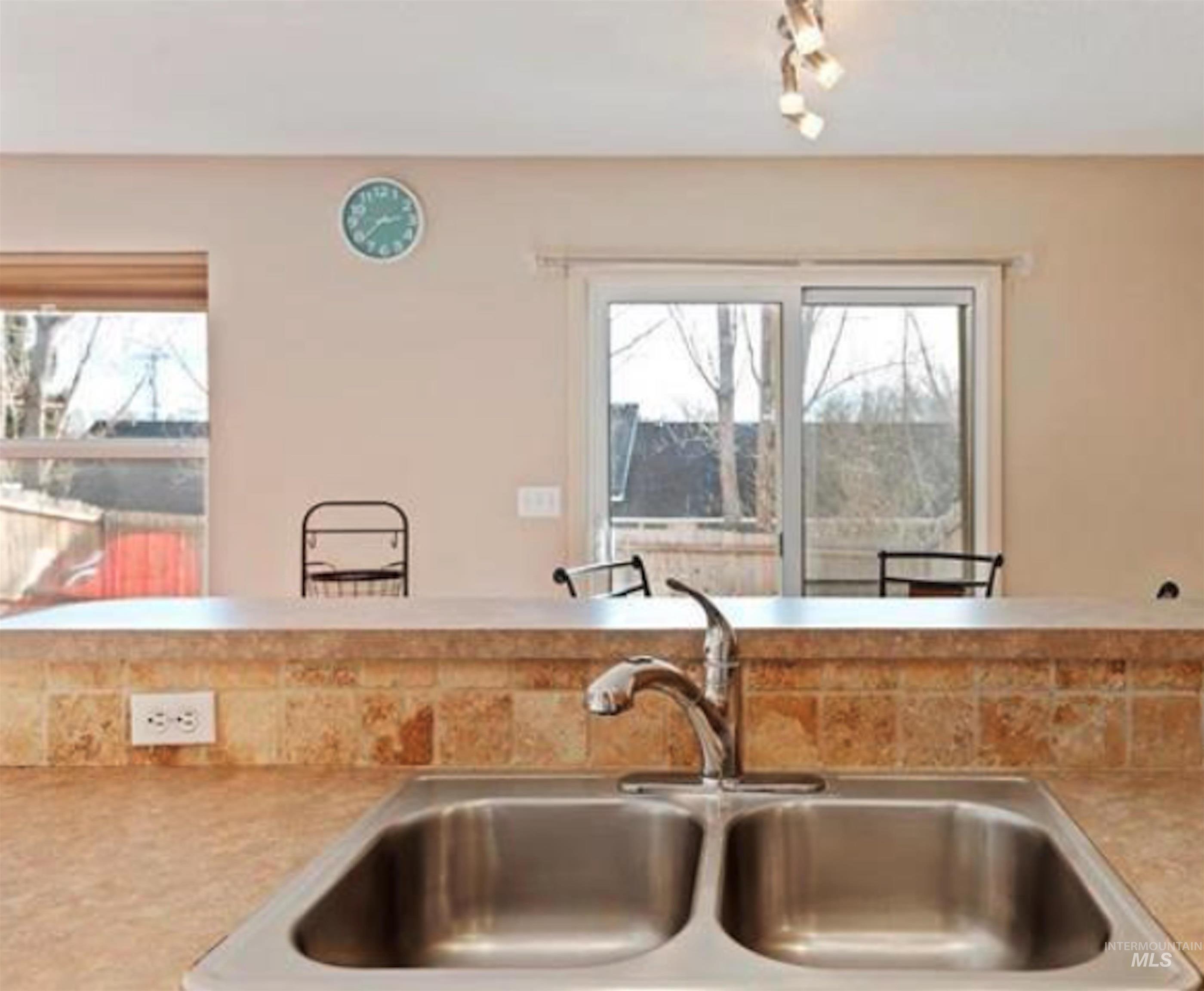 Kitchen with light countertops and a sink