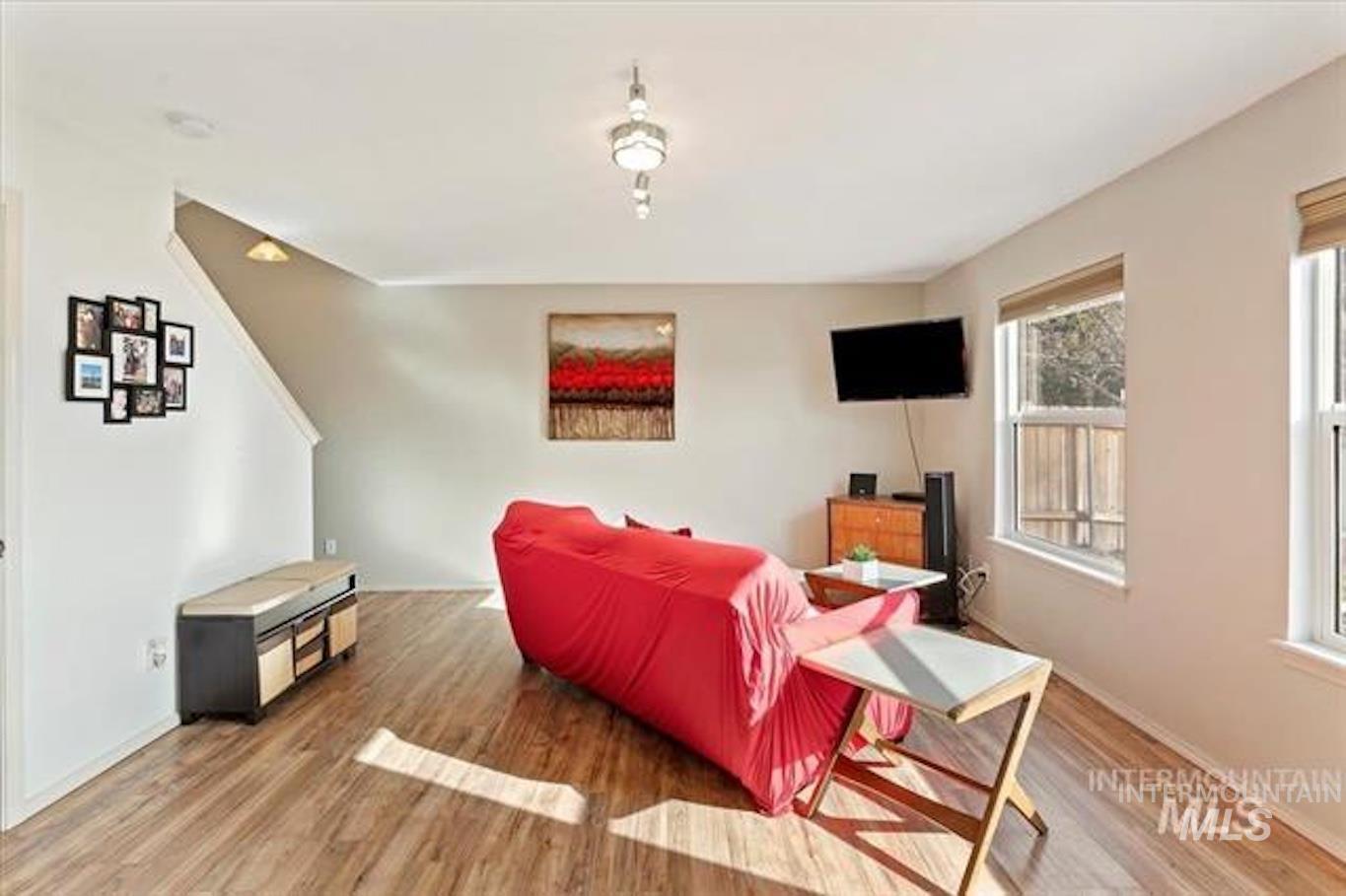 Living room with light wood-type flooring and baseboards