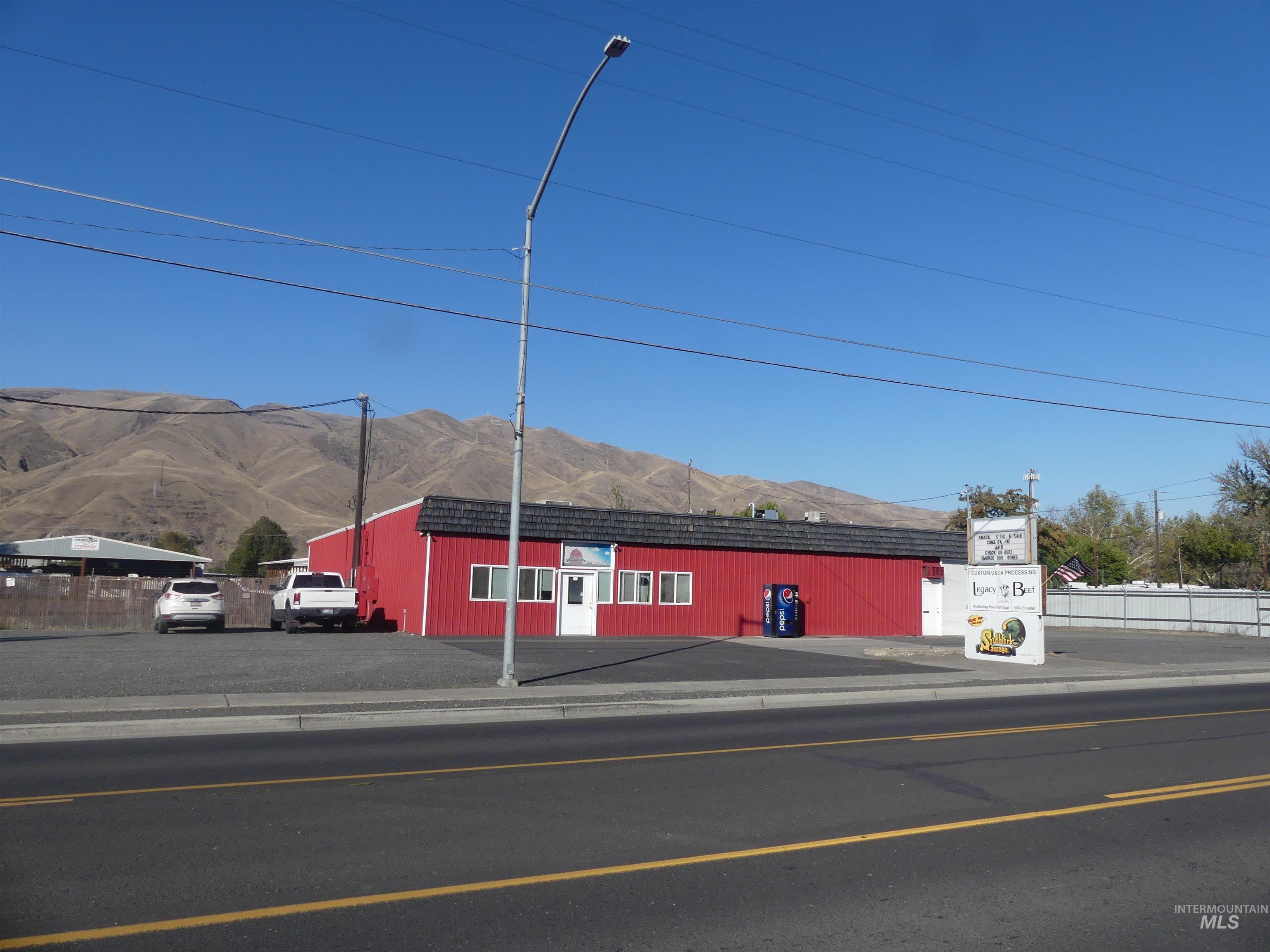 View of asphalt road with sidewalks, curbs, and a mountain view