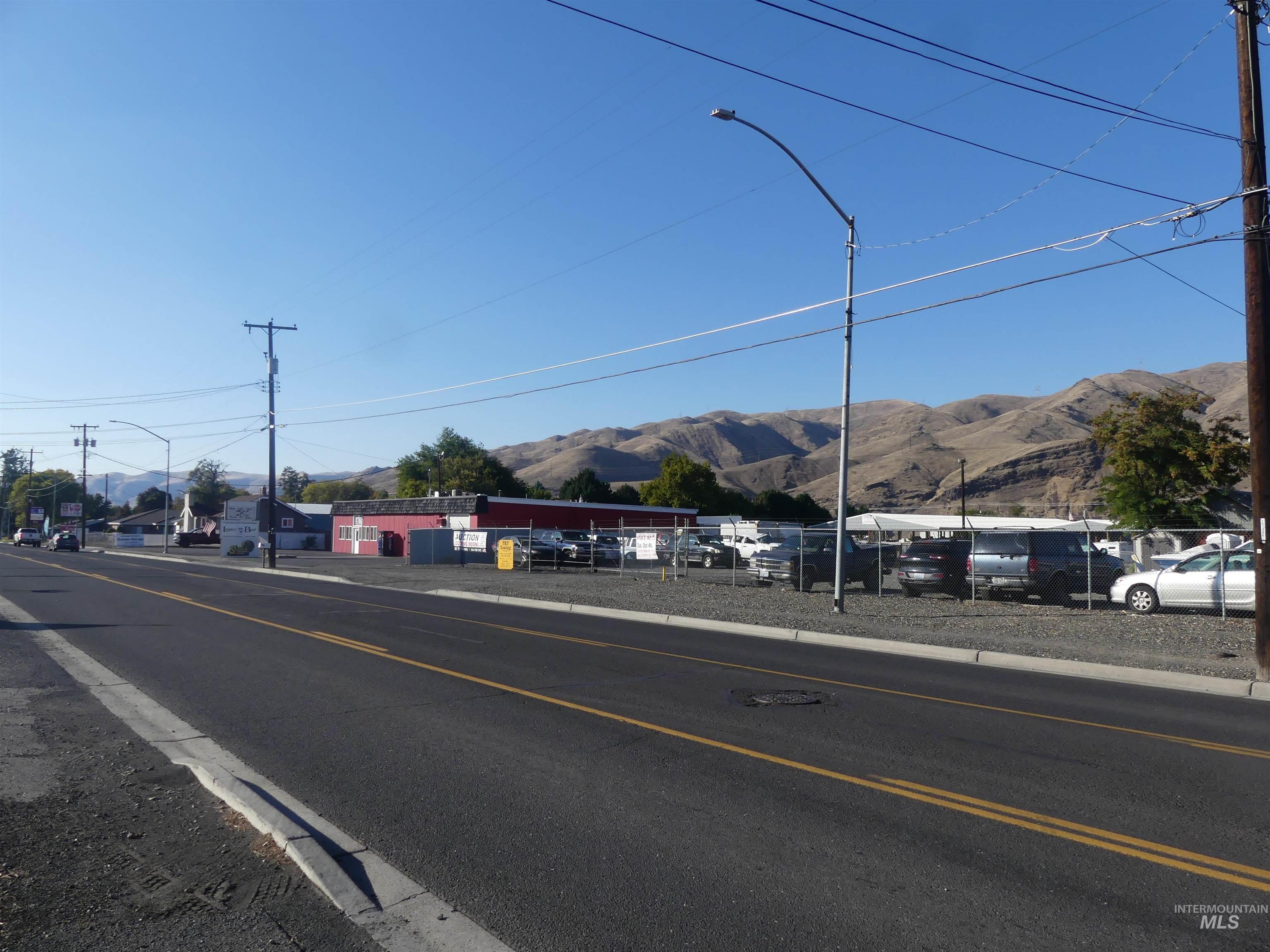 View of asphalt street with street lights and a mountain view