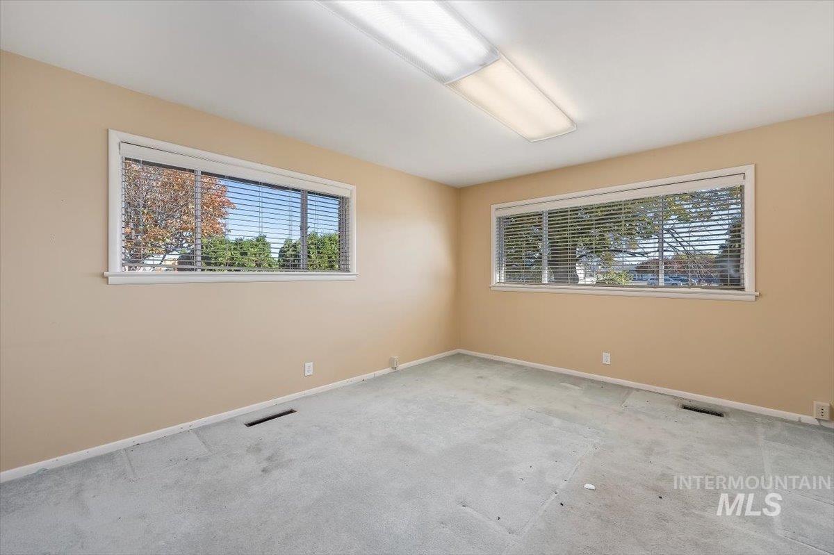 Carpeted spare room with baseboards