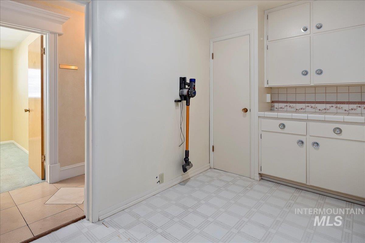 Washroom featuring baseboards and light flooring