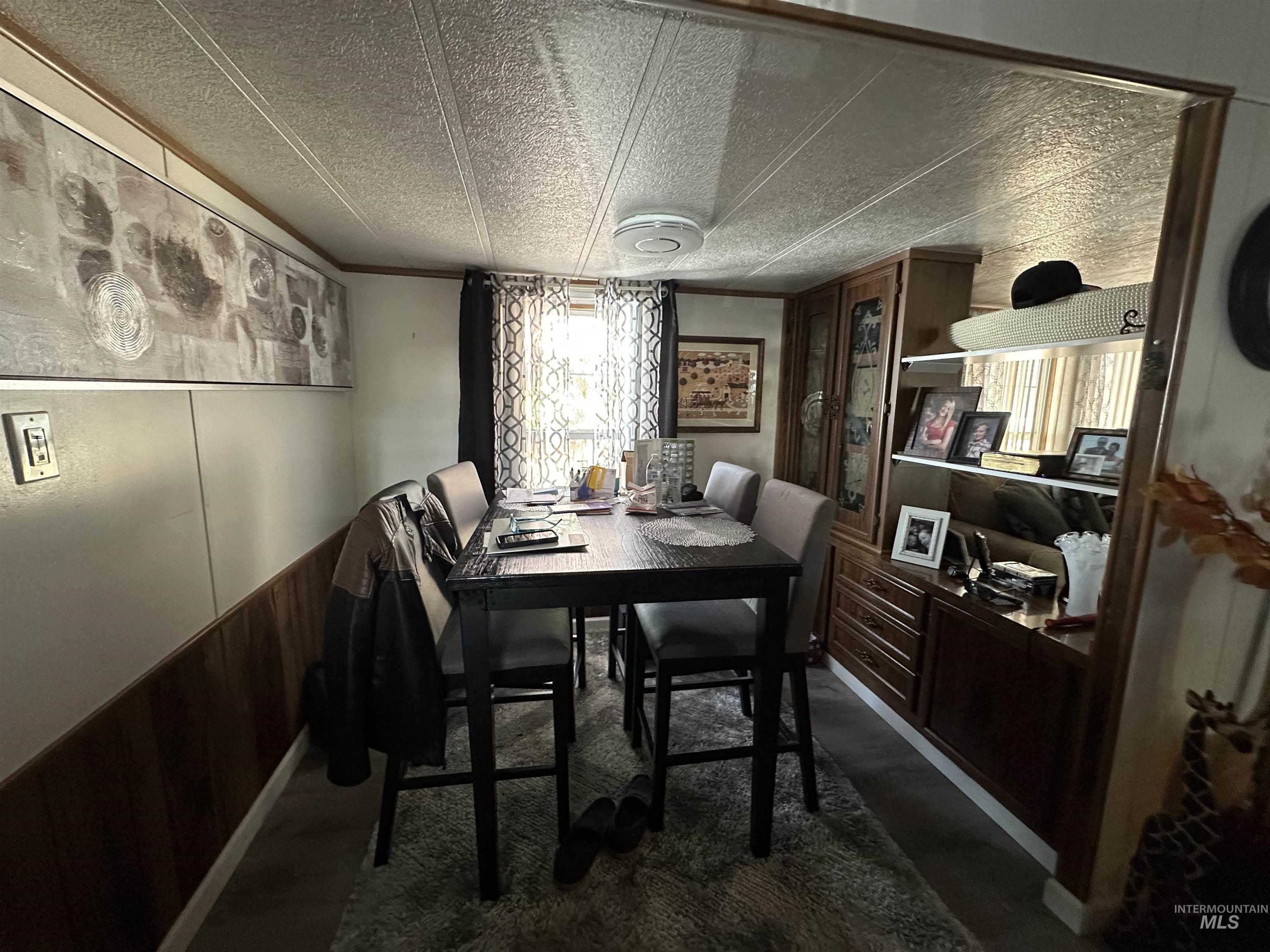 Dining space featuring wood walls