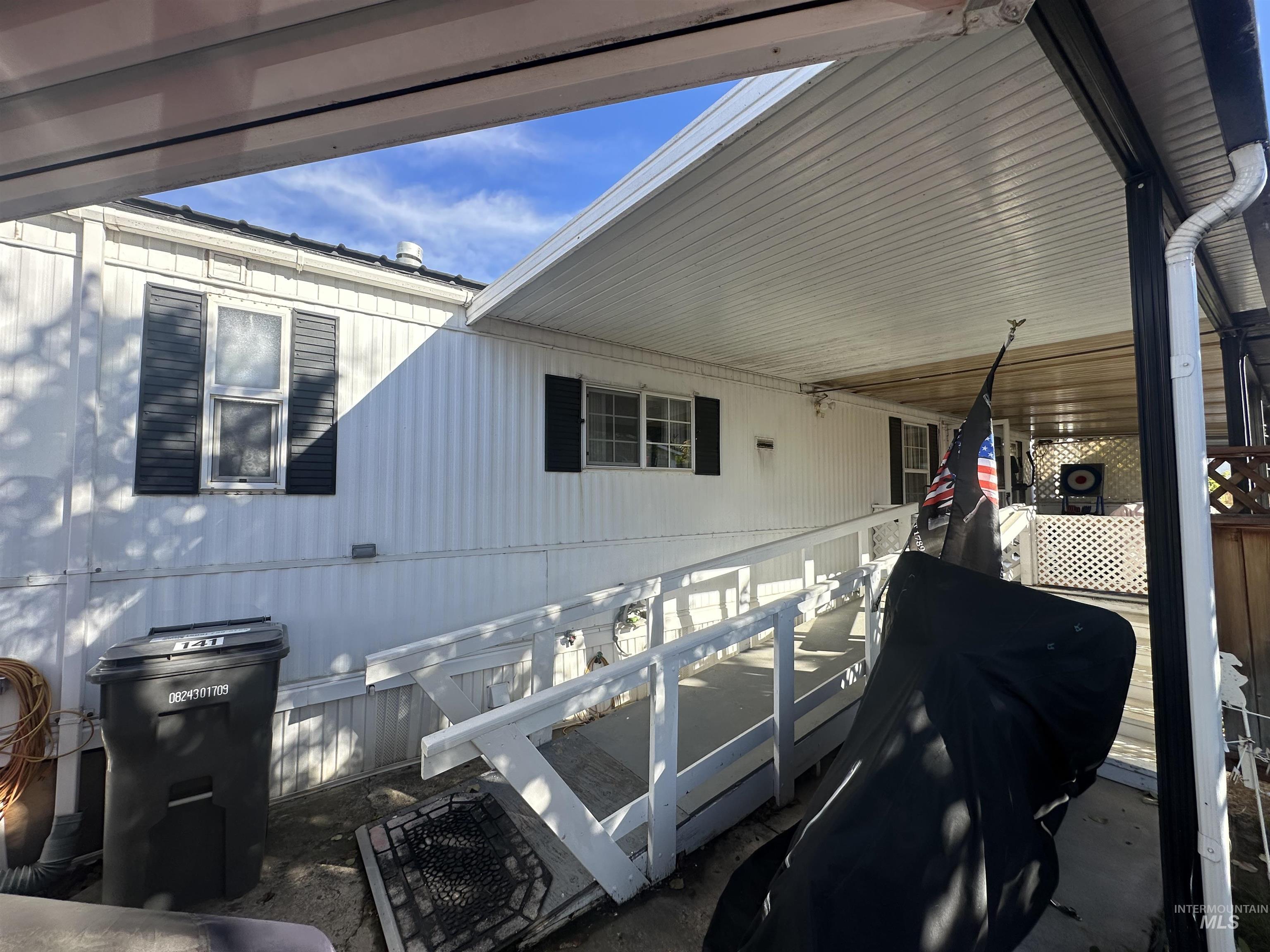 View of side of property featuring a patio area and a deck
