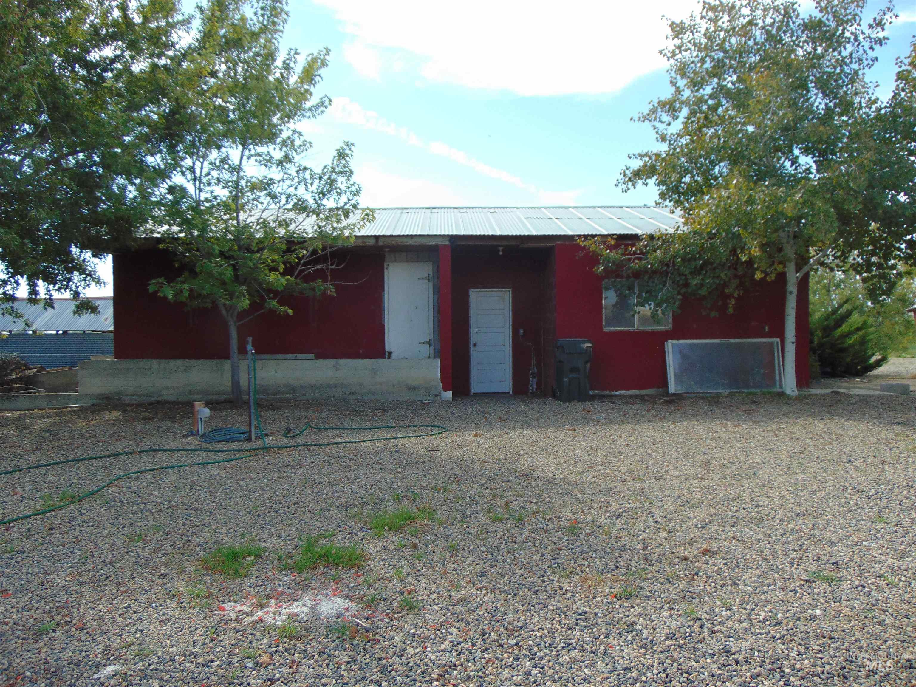 Rear view of property featuring a metal roof