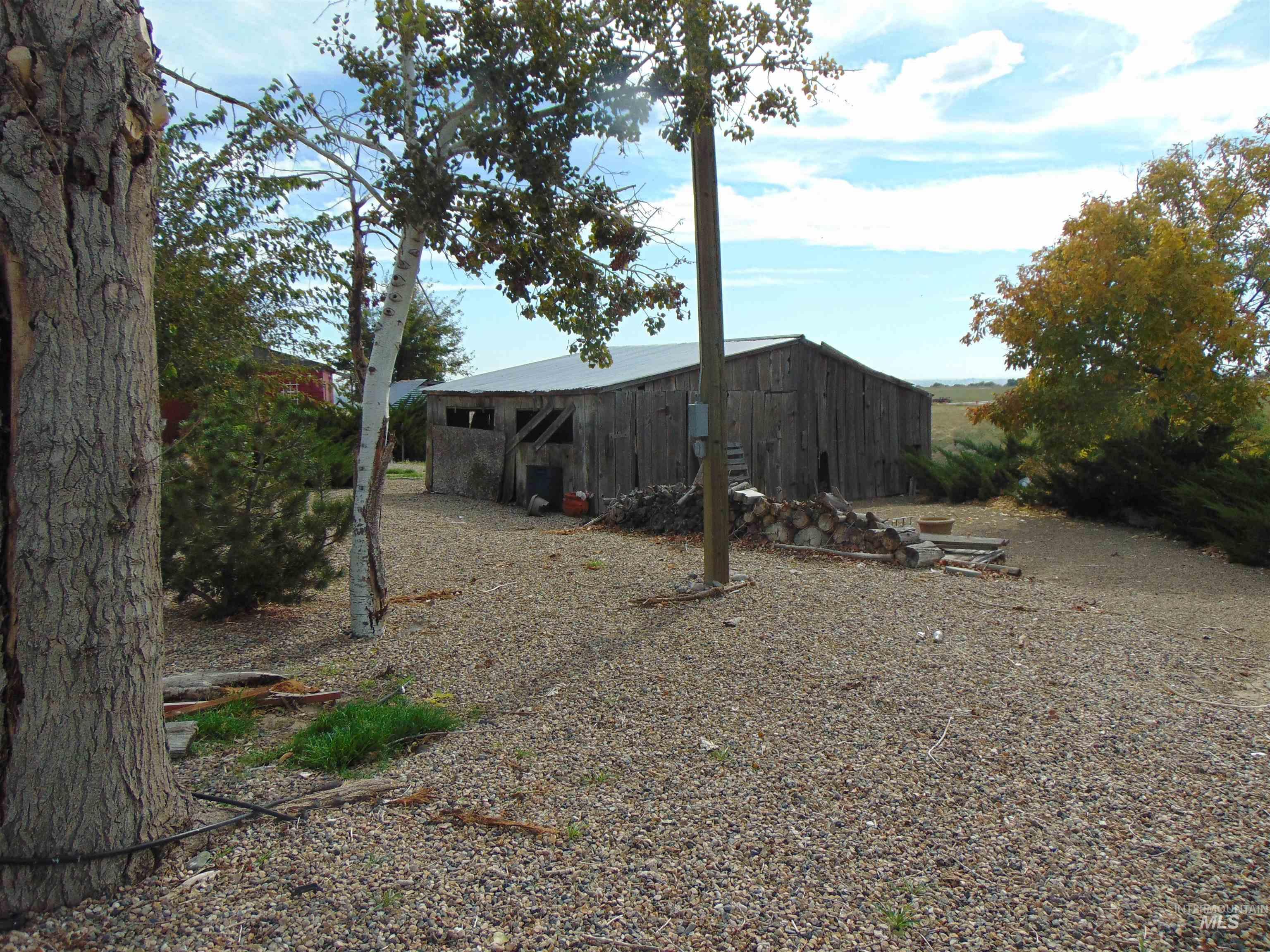 View of yard featuring a pole building and an outbuilding