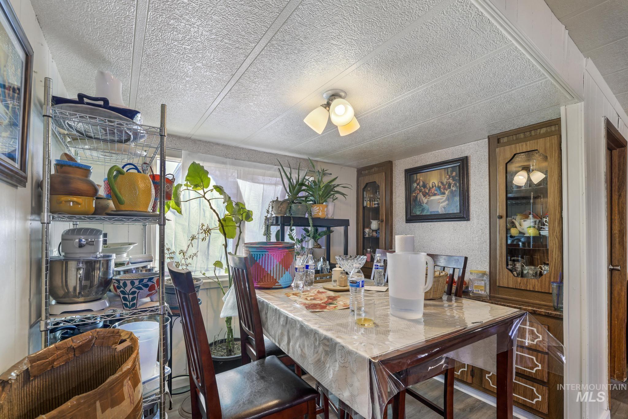 Dining space featuring wood finished floors and a textured ceiling