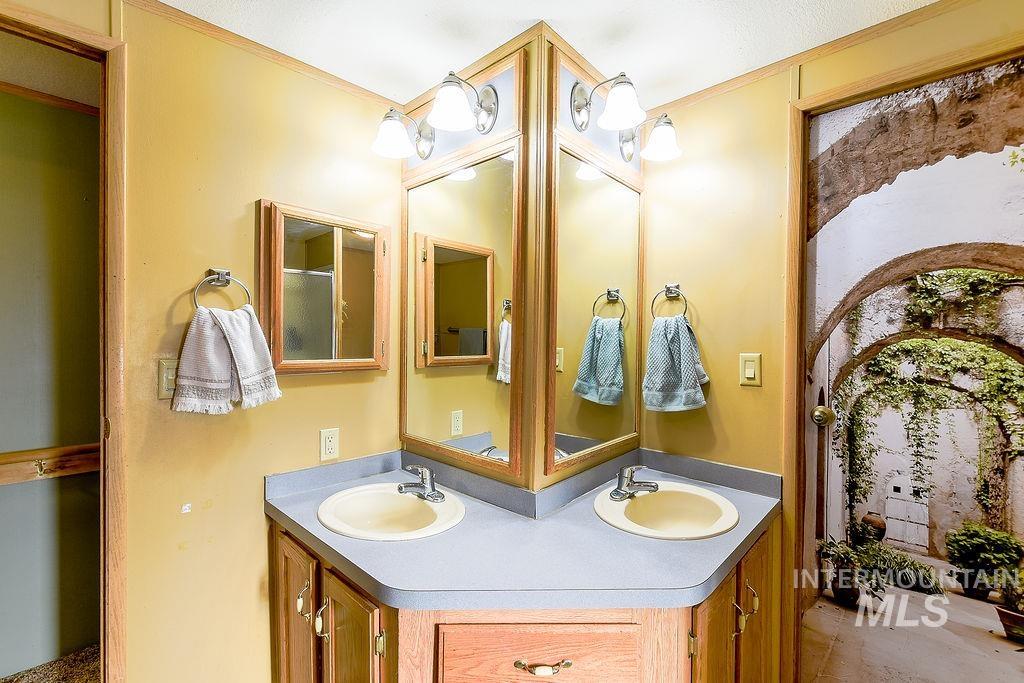 Bathroom featuring double vanity and ornamental molding