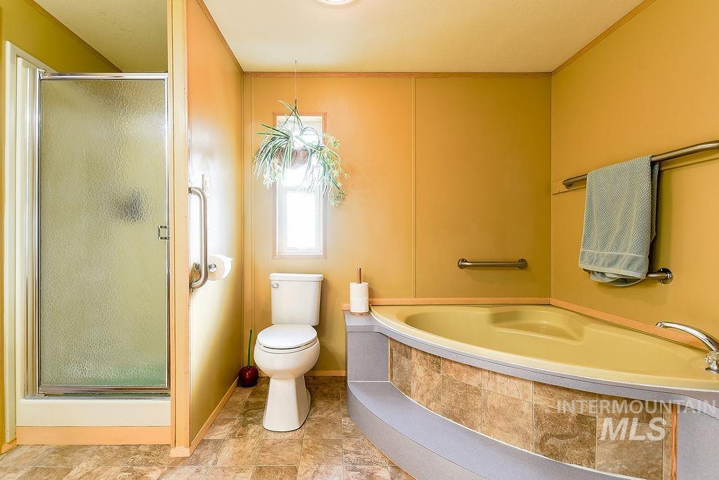 Bathroom with a shower stall and a bath