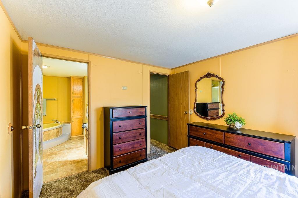 Bedroom featuring a textured ceiling and carpet floors