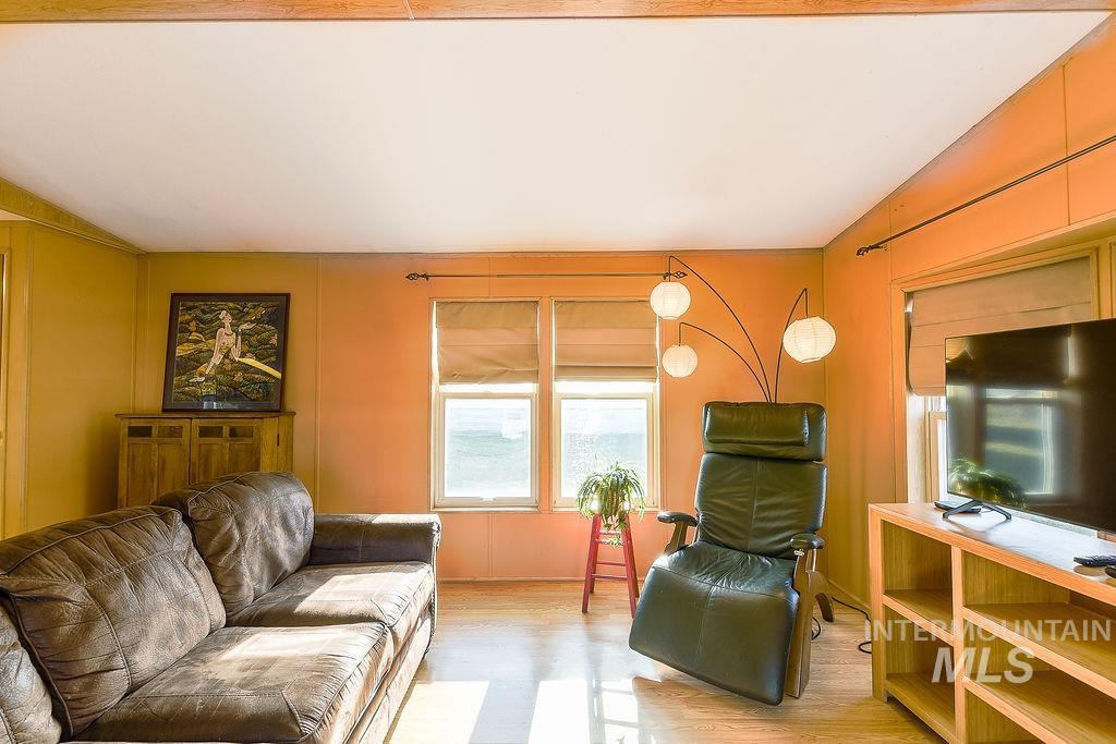 Living area with light wood-type flooring and baseboards