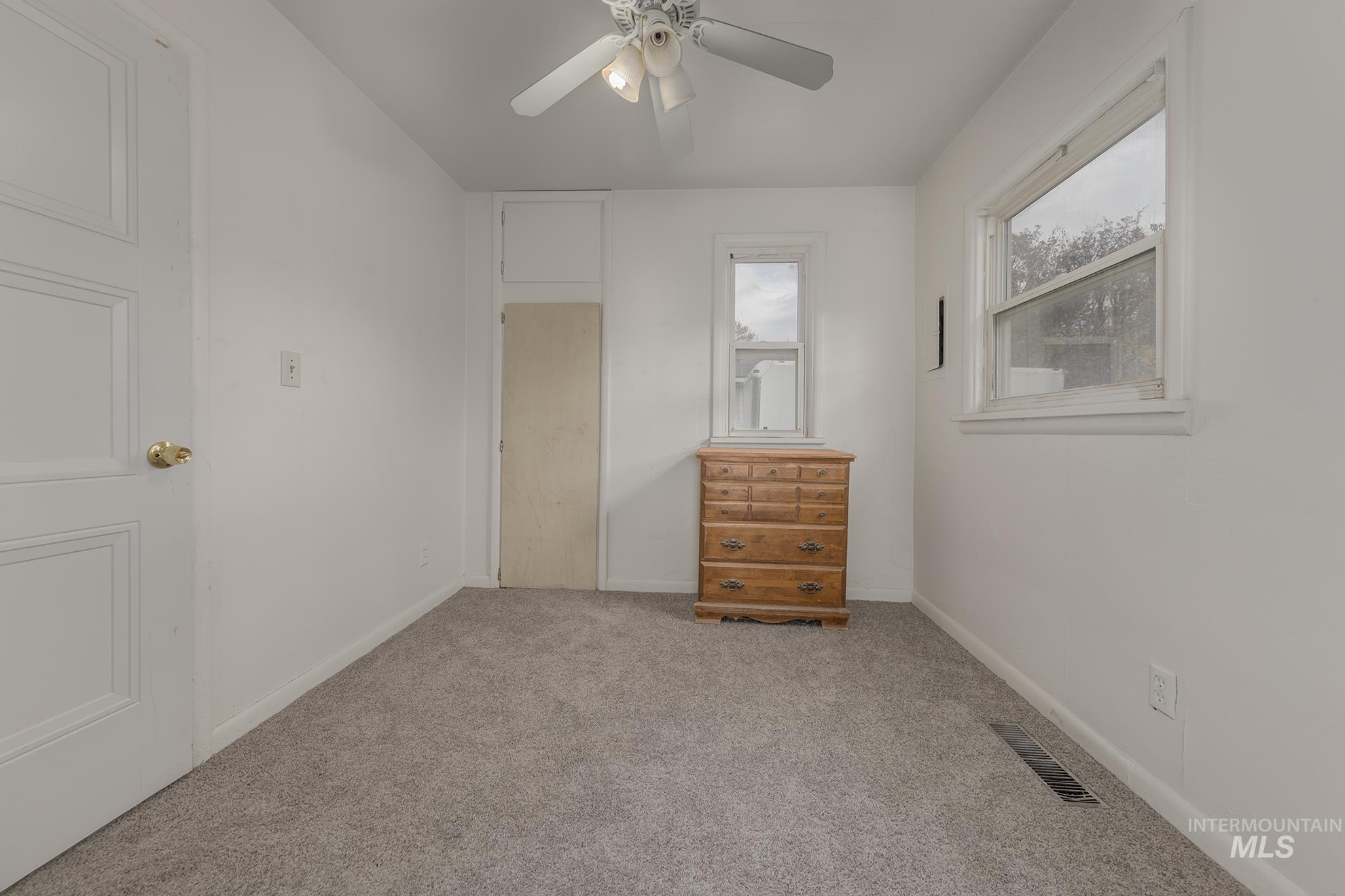Unfurnished bedroom featuring carpet flooring and a ceiling fan