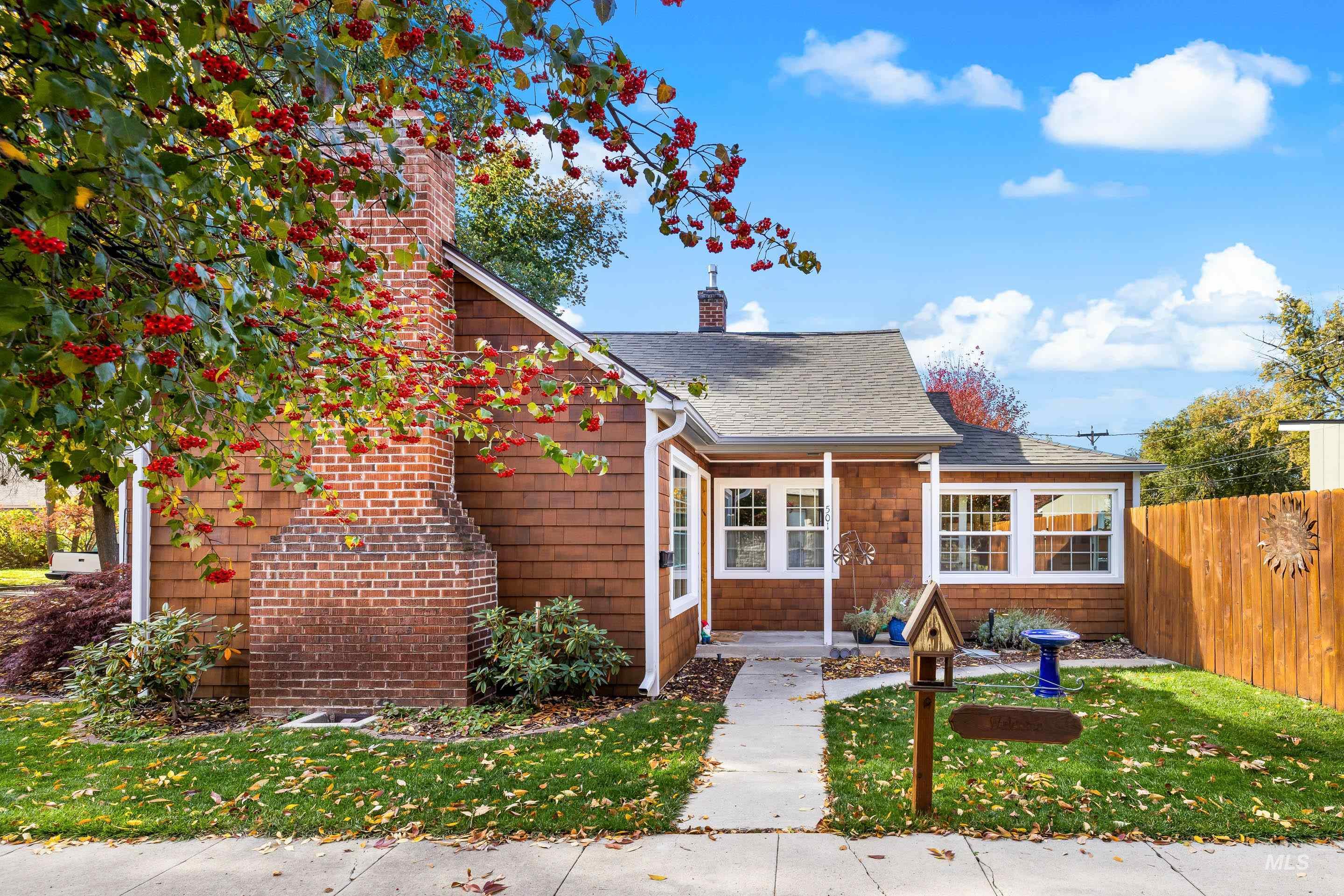 Bungalow-style home featuring a chimney and a shingled roof