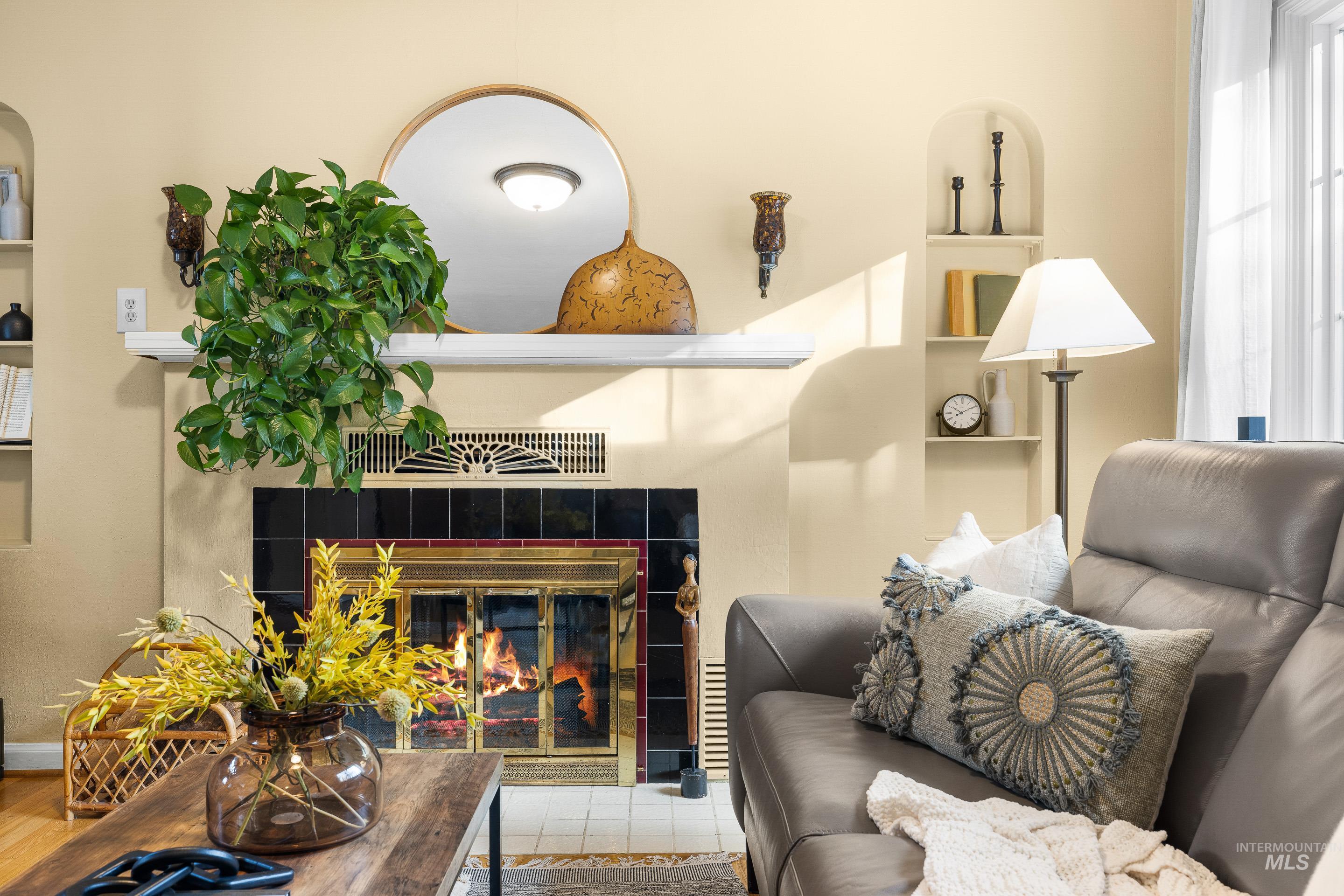 Living area featuring built in shelves, a fireplace, and plenty of natural light