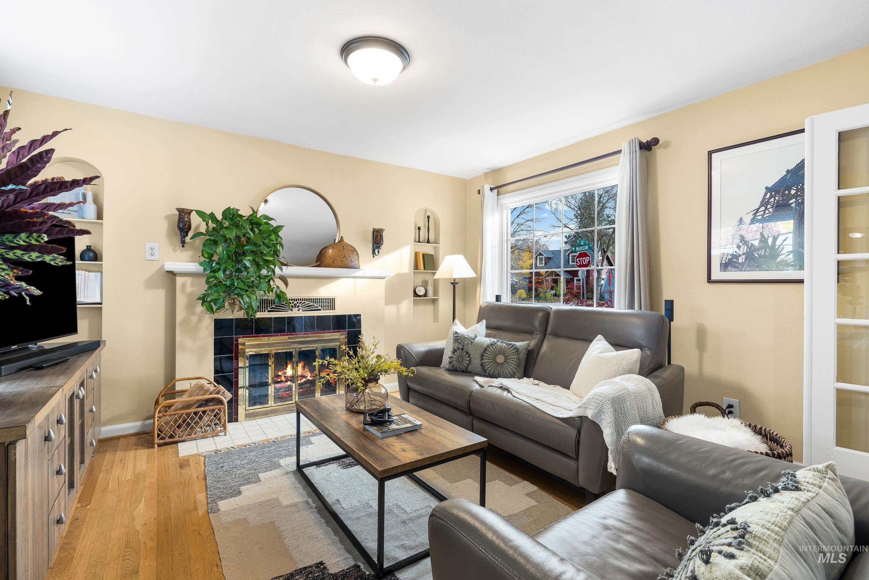 Living room featuring light wood-style floors and a fireplace