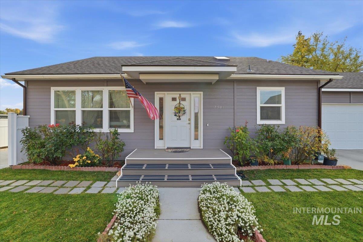View of front of home featuring a shingled roof