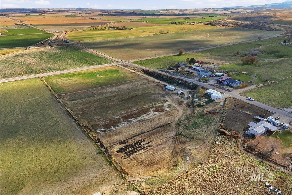Aerial overview of property's location with rural landscape and large plots for crops
