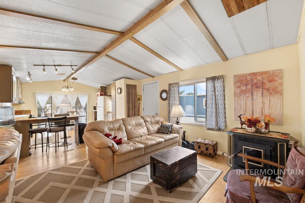 Living room with vaulted ceiling and wood finished floors