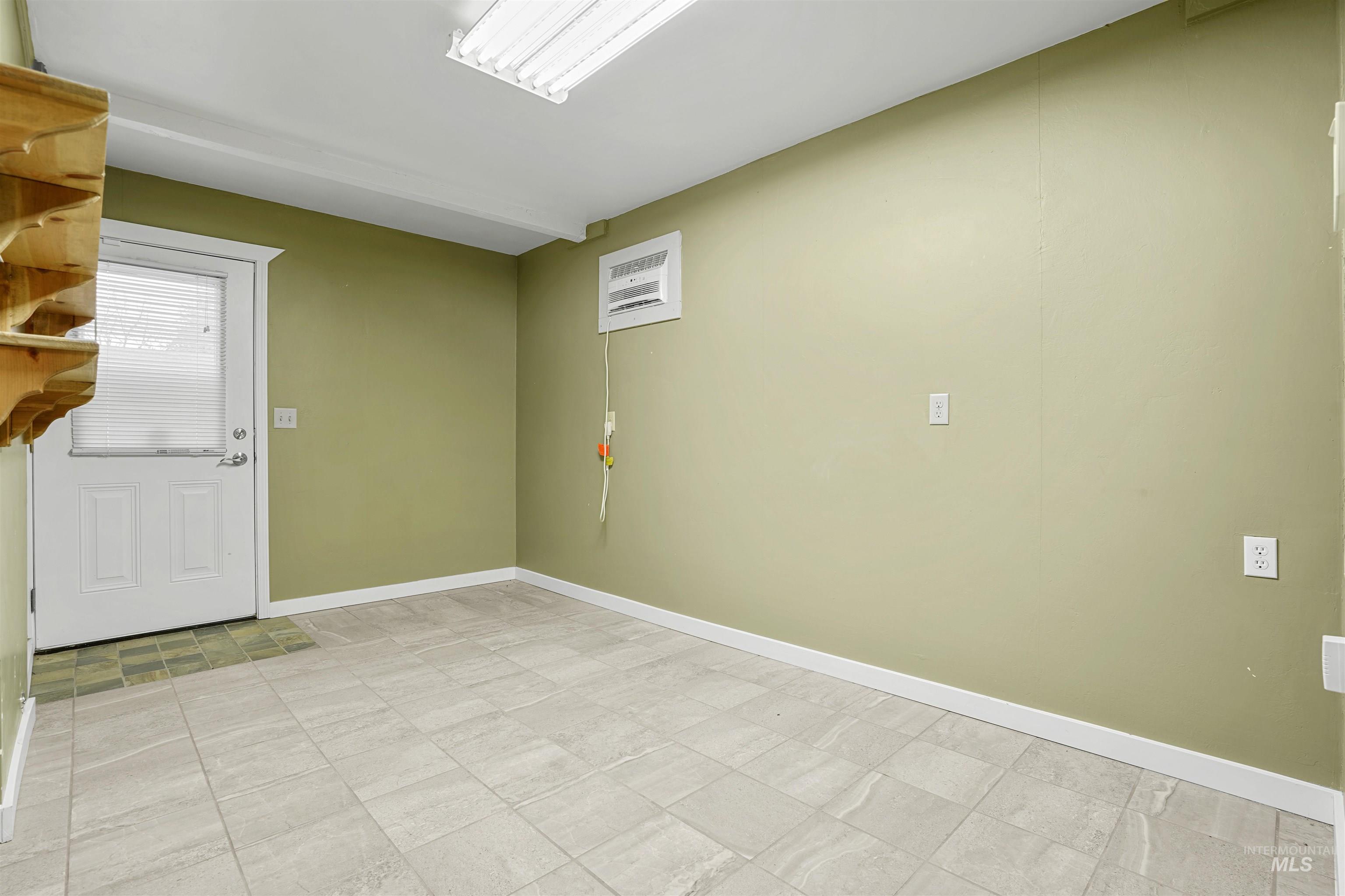Unfurnished room featuring baseboards